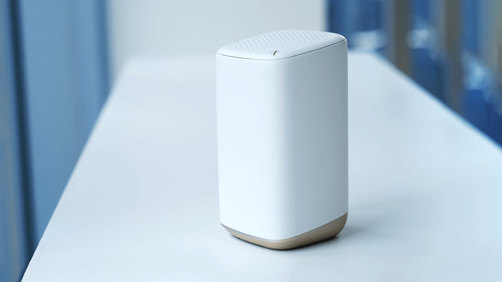 A white Comcast Xfinity router is set on a table.