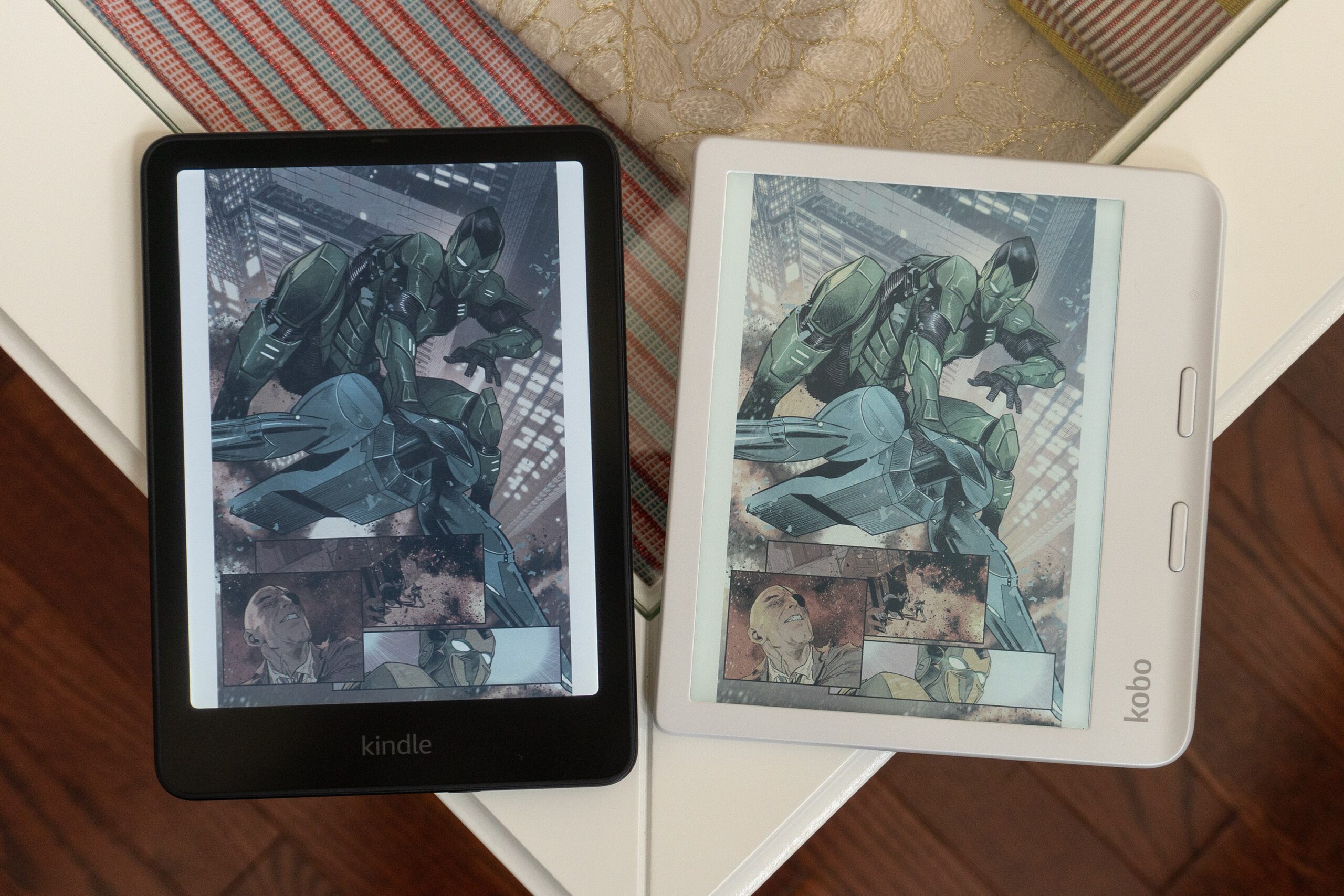 The Amazon Kindle Colorsoft e-reader sitting next to the Kobo Clara Colour displaying a Spider-Man comic.