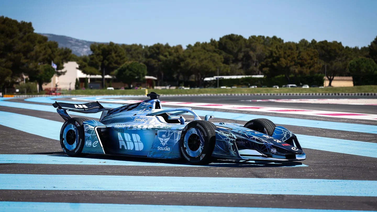 A blue and black Formula E Gen4 car on a race track