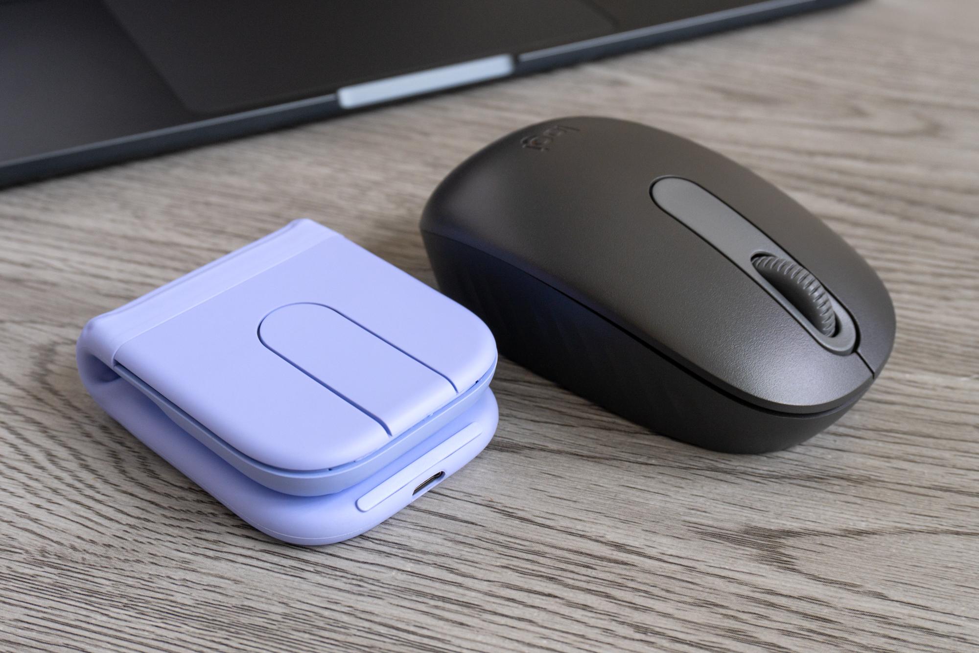 The Logitech Mobi Fold mouse next to another compact Logitech mouse featuring a scroll wheel. The Logitech Mobi Fold mouse next to another compact Logitech mouse featuring a scroll wheel.
