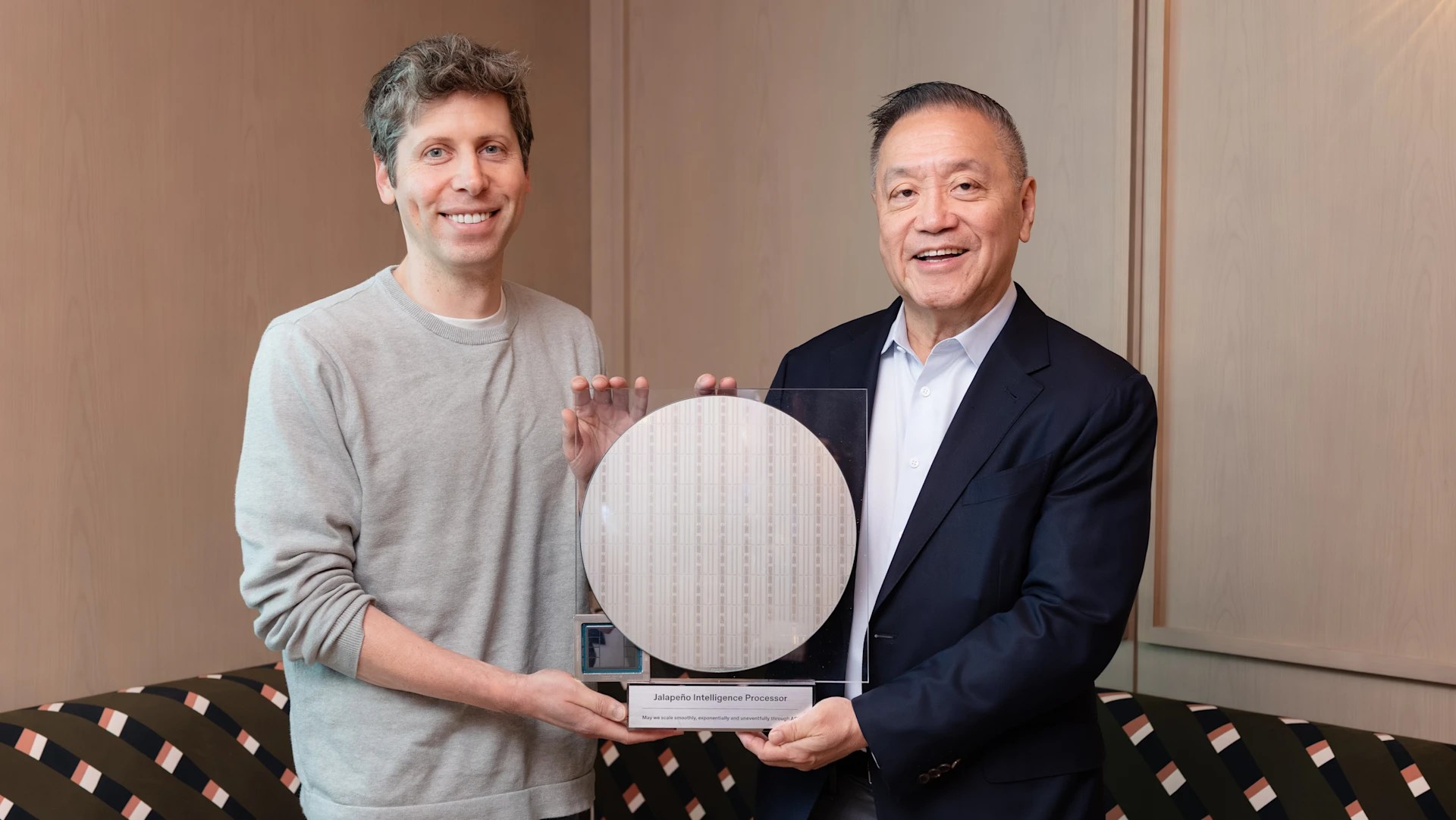 A photo of Sam Altman and Hock Tan holding an AI chip
