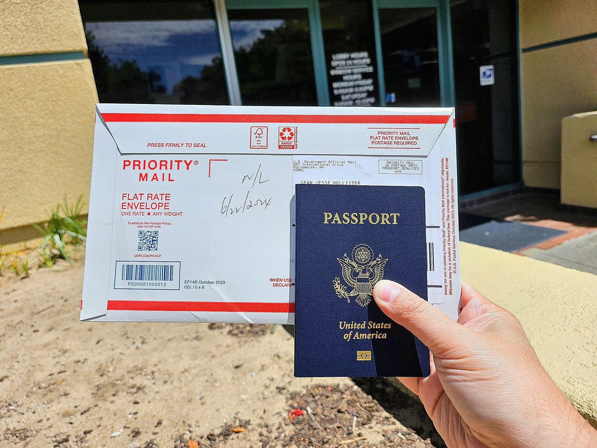 A photo of a person holding a US passport and an envelope.