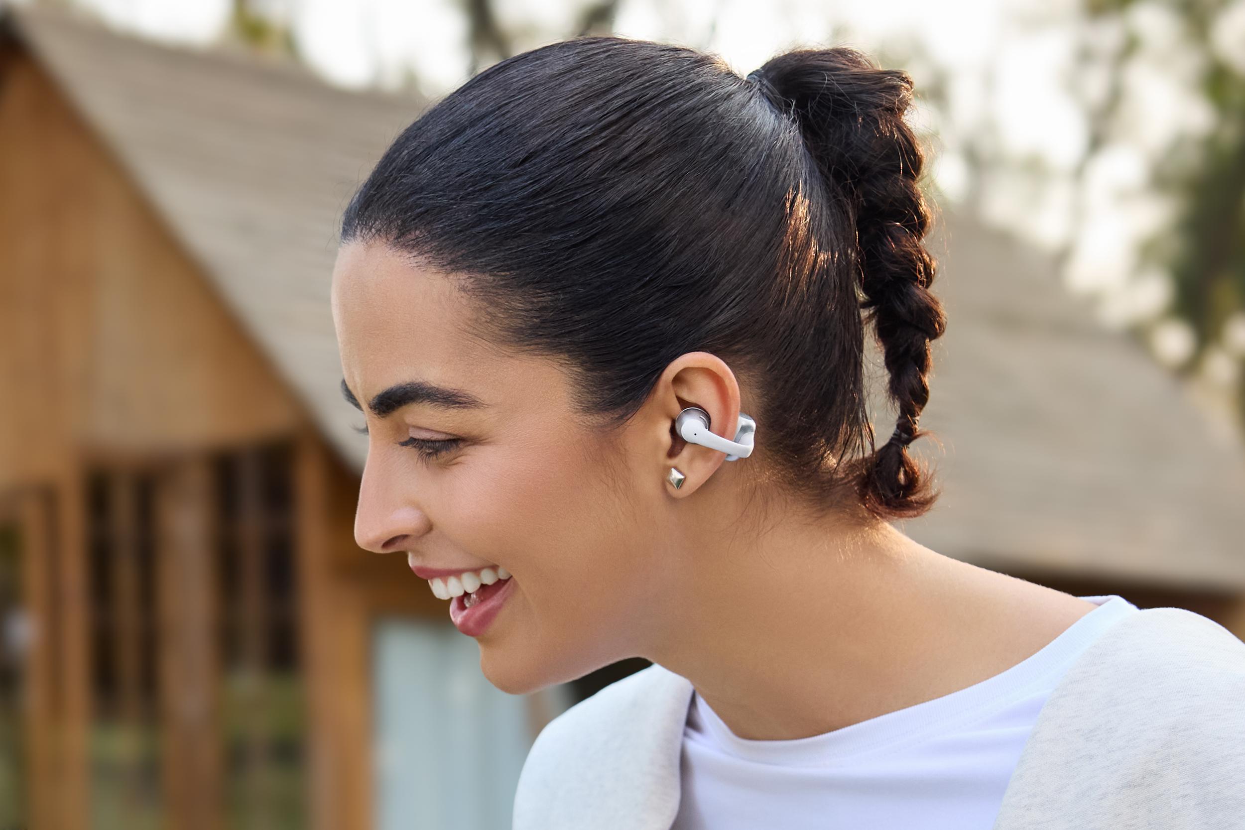 A person wearing the Shokz OpenDots 2 wireless earbuds.