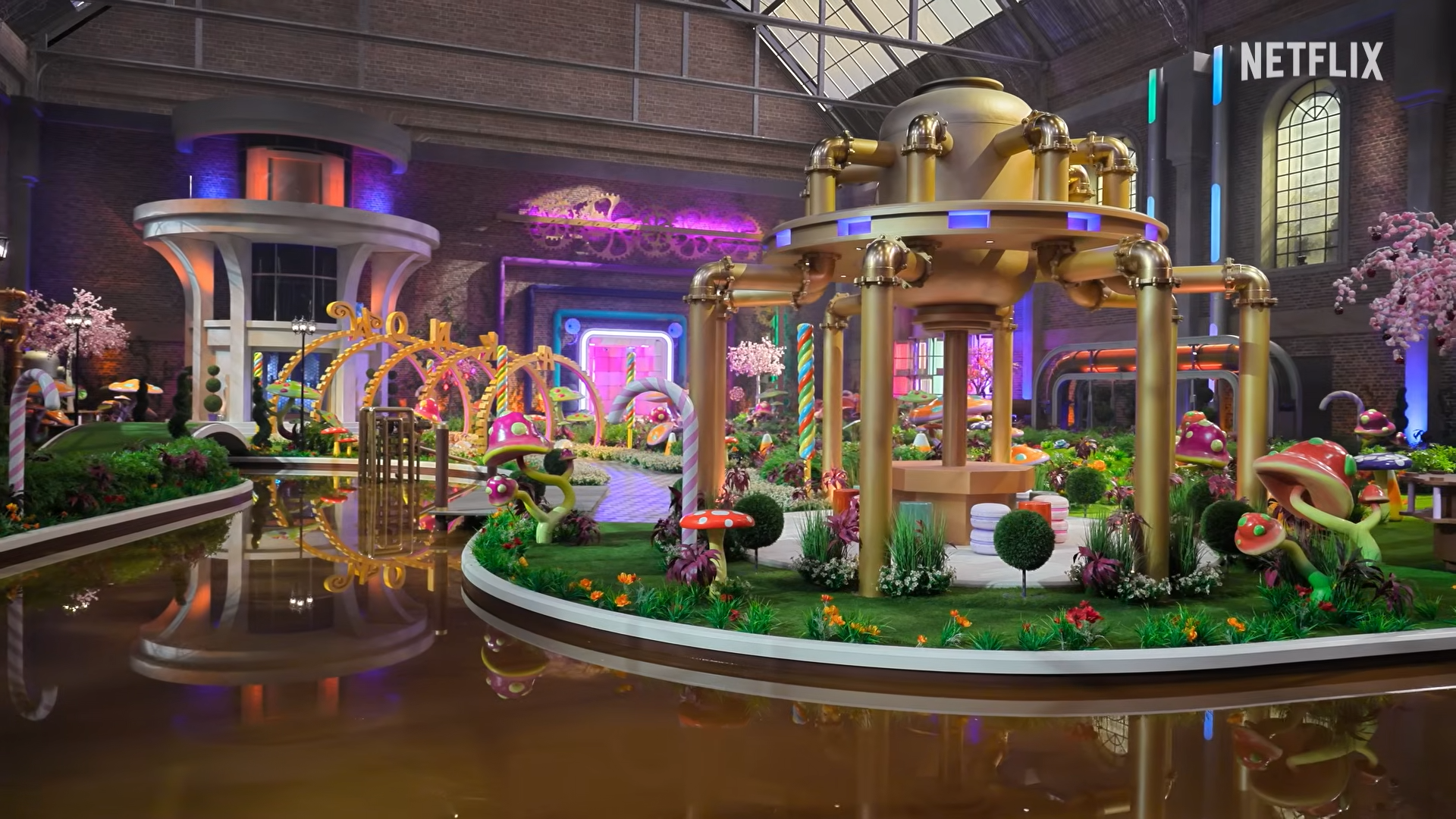 Image of the chocolate factory from Netflix’s reality show with a chocolate river and various tubes.