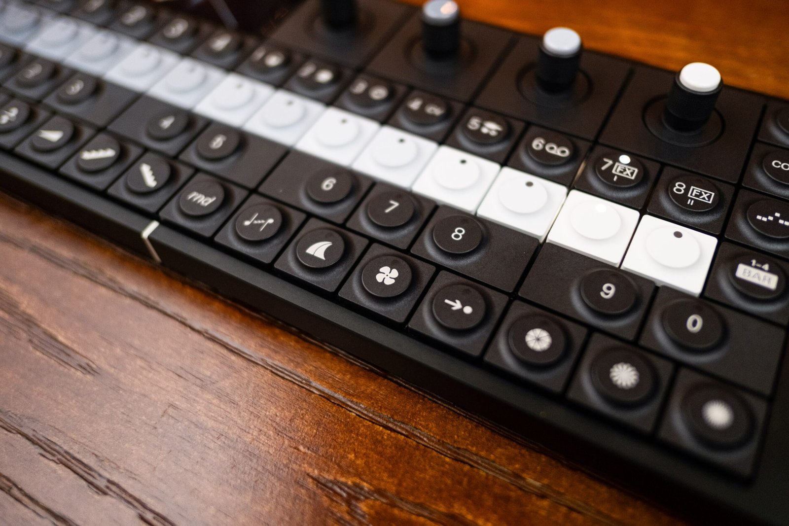Close-up of OP-XY with four rows of buttons and several visible knobs.