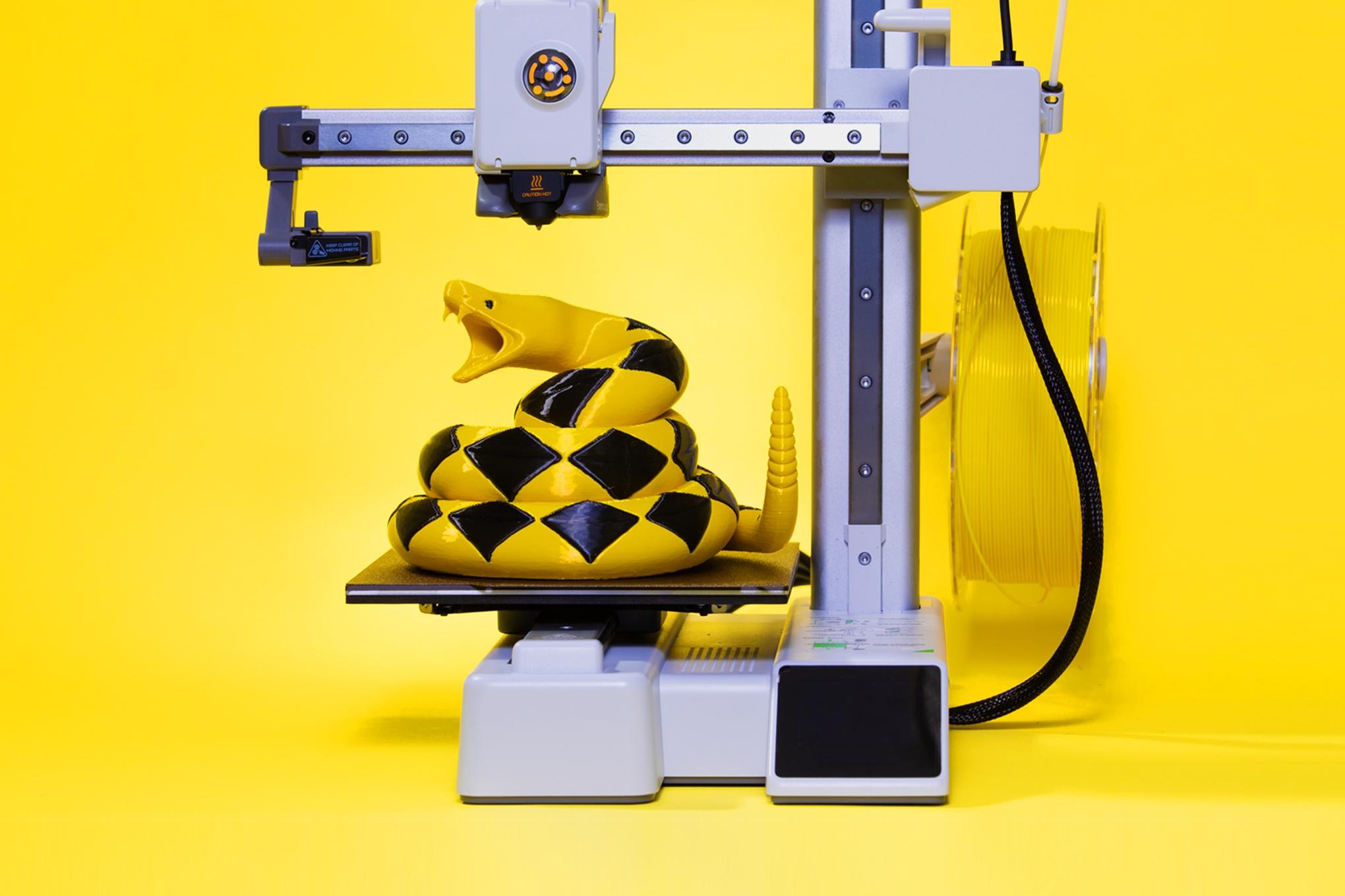 Sculpture of a snake sitting on a 3D print bed.