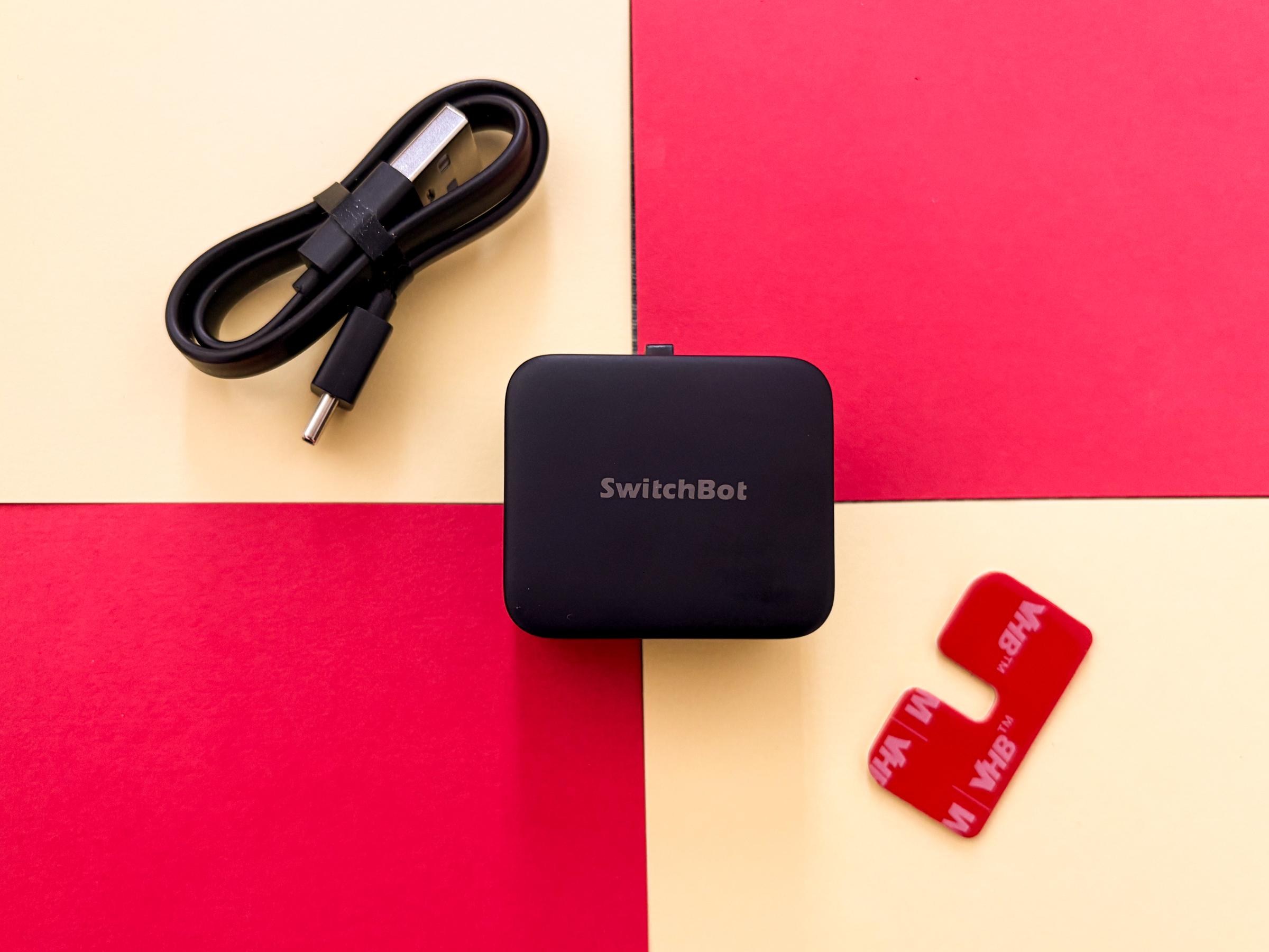 The SwitchBot Bot Rechargeable pictured with its charging cable.