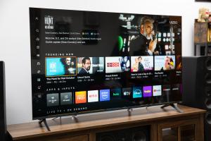 The Vizio Mini LED Quantum display the Vizio OS home page, on a wooden credenza.