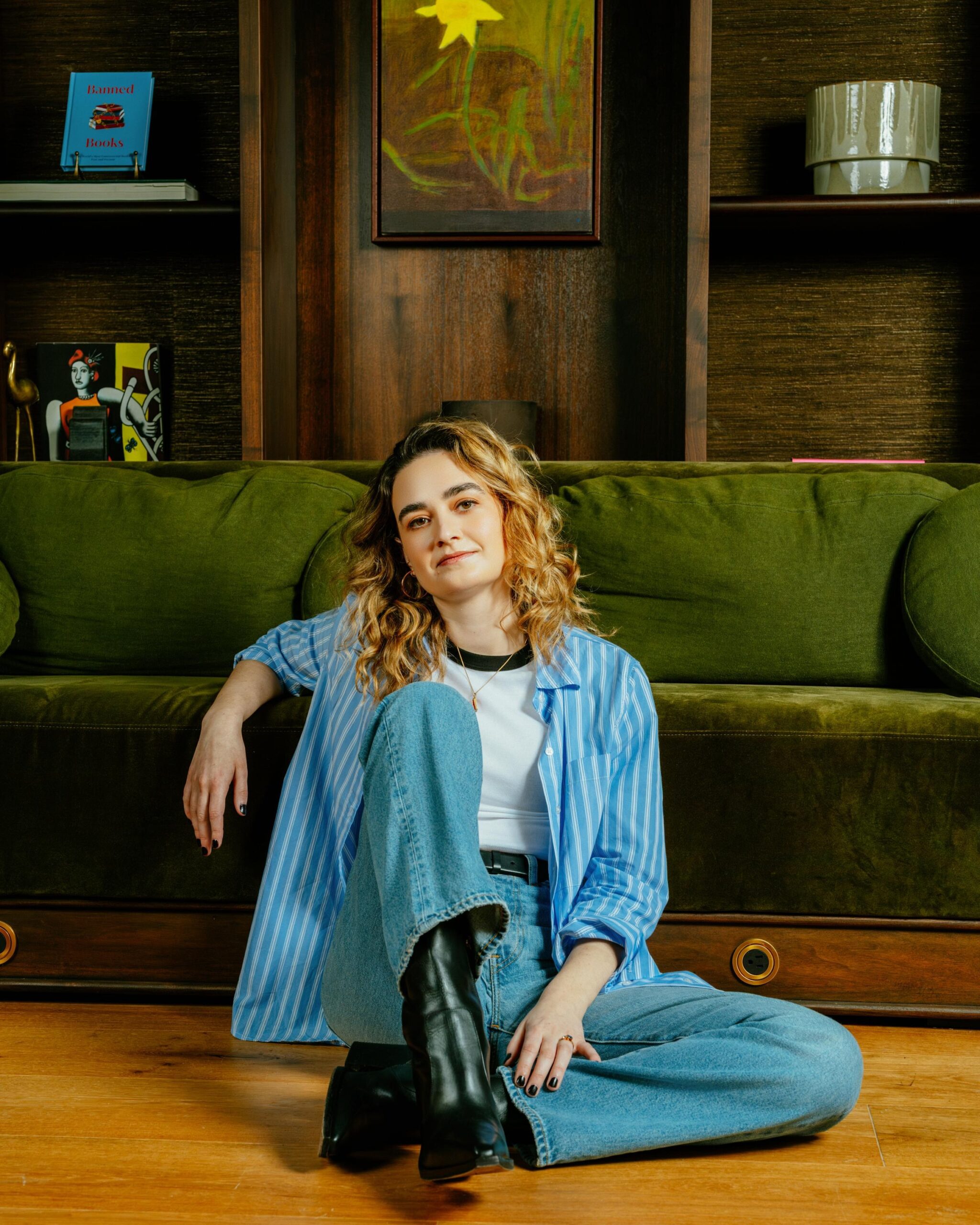 Carter Sherman sitting on a the floor in front of a couch, instead of just on it for some reason.