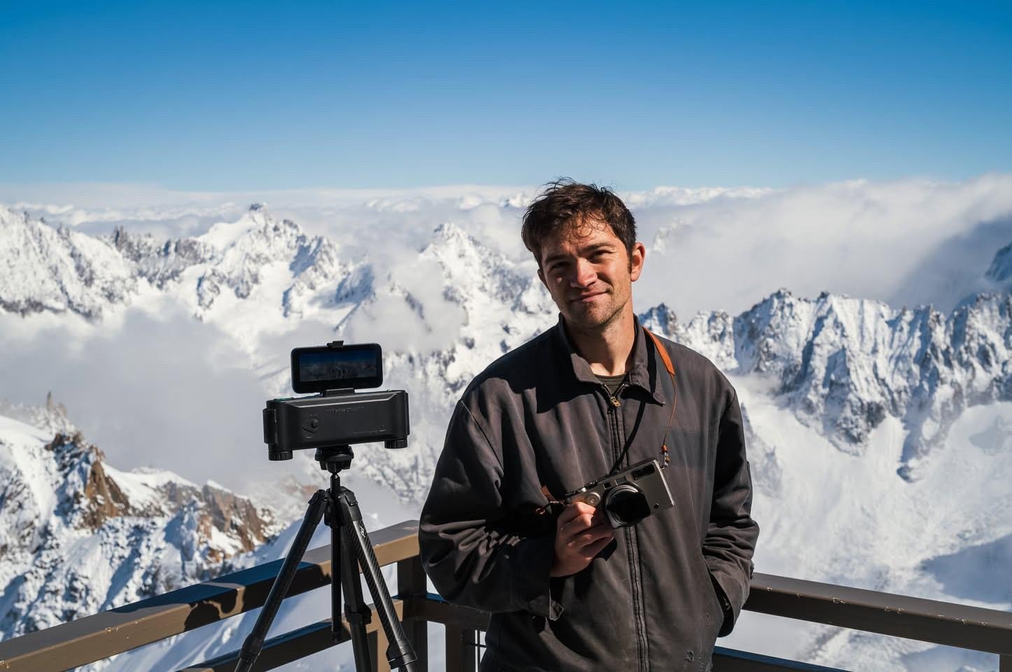 David Imel on top of a mountain shooting a 3D-printed camera