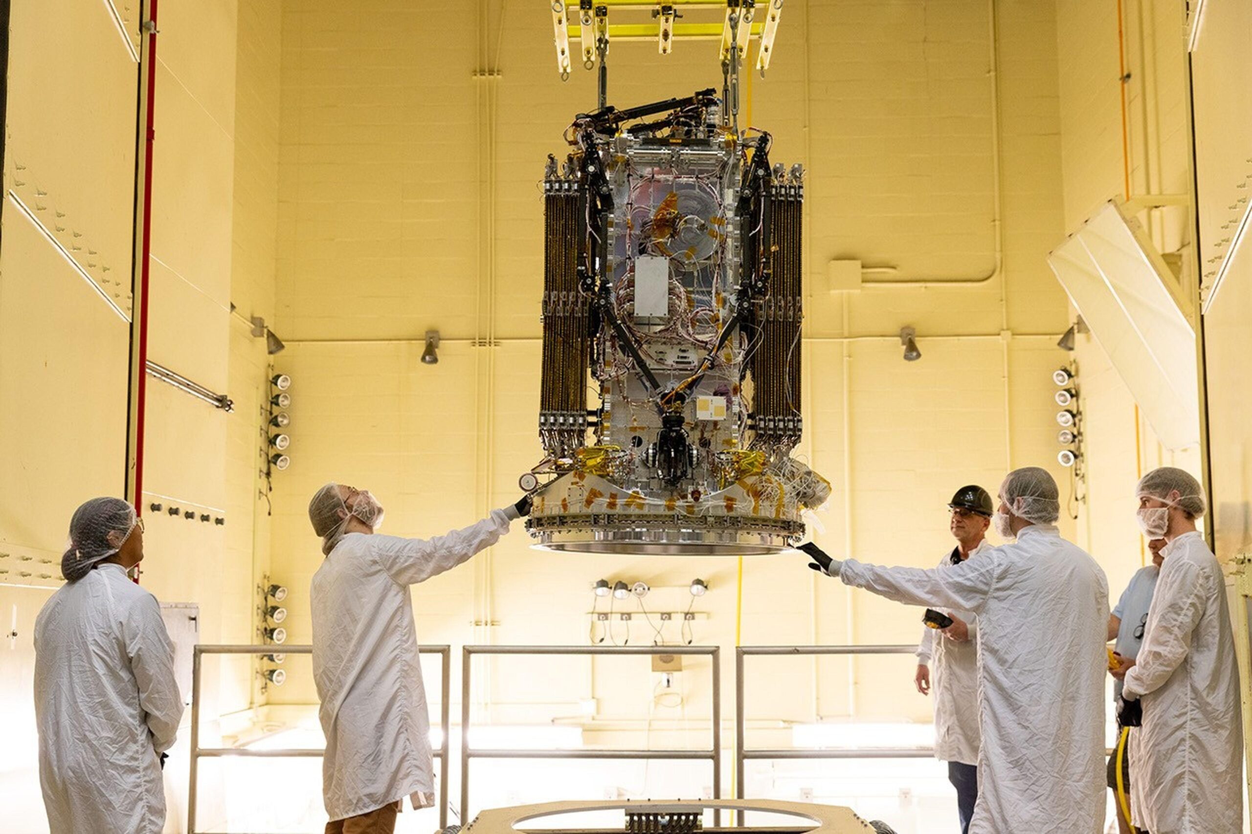 Engineers from Katalyst Space Technologies in Flagstaff, Ariz., stabilize their LINK robotic servicing spacecraft as it moves into a vibration chamber at NASA’s Goddard Space Flight Center in Greenbelt, Md., on April 15, 2026. The vibration chamber simulated the intense shaking LINK will experience during launch.