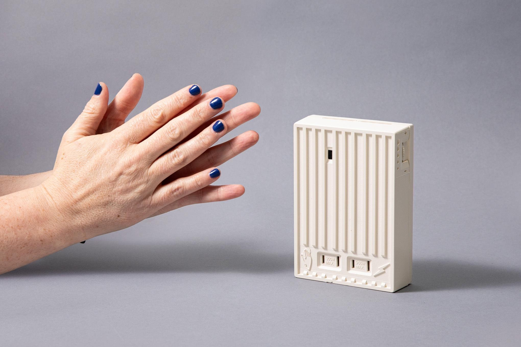 A photo of two hands clapping, next to a large beige box — The Clapper.