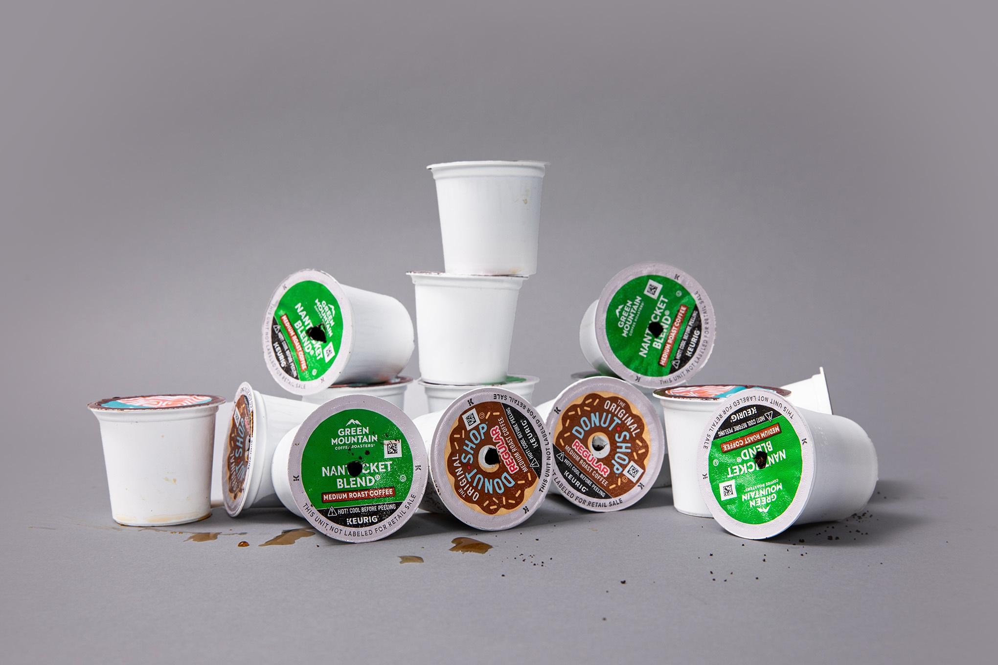 A photo of a pile of Keurig K-Cups on a gray background.