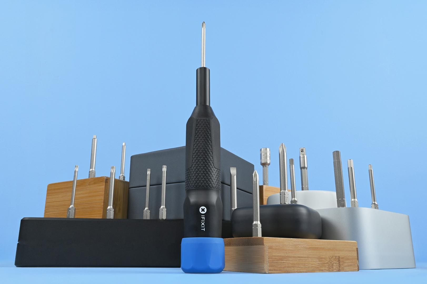 The tools and bits included in the iFixit Megalodon Driver Kit against a blue background.