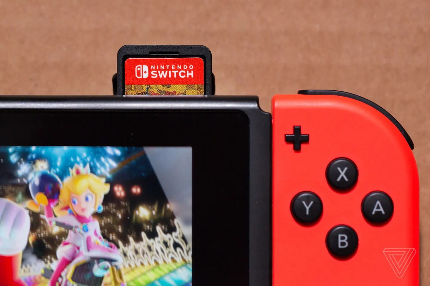 A photo showing a Nintendo Switch with a game cartridge