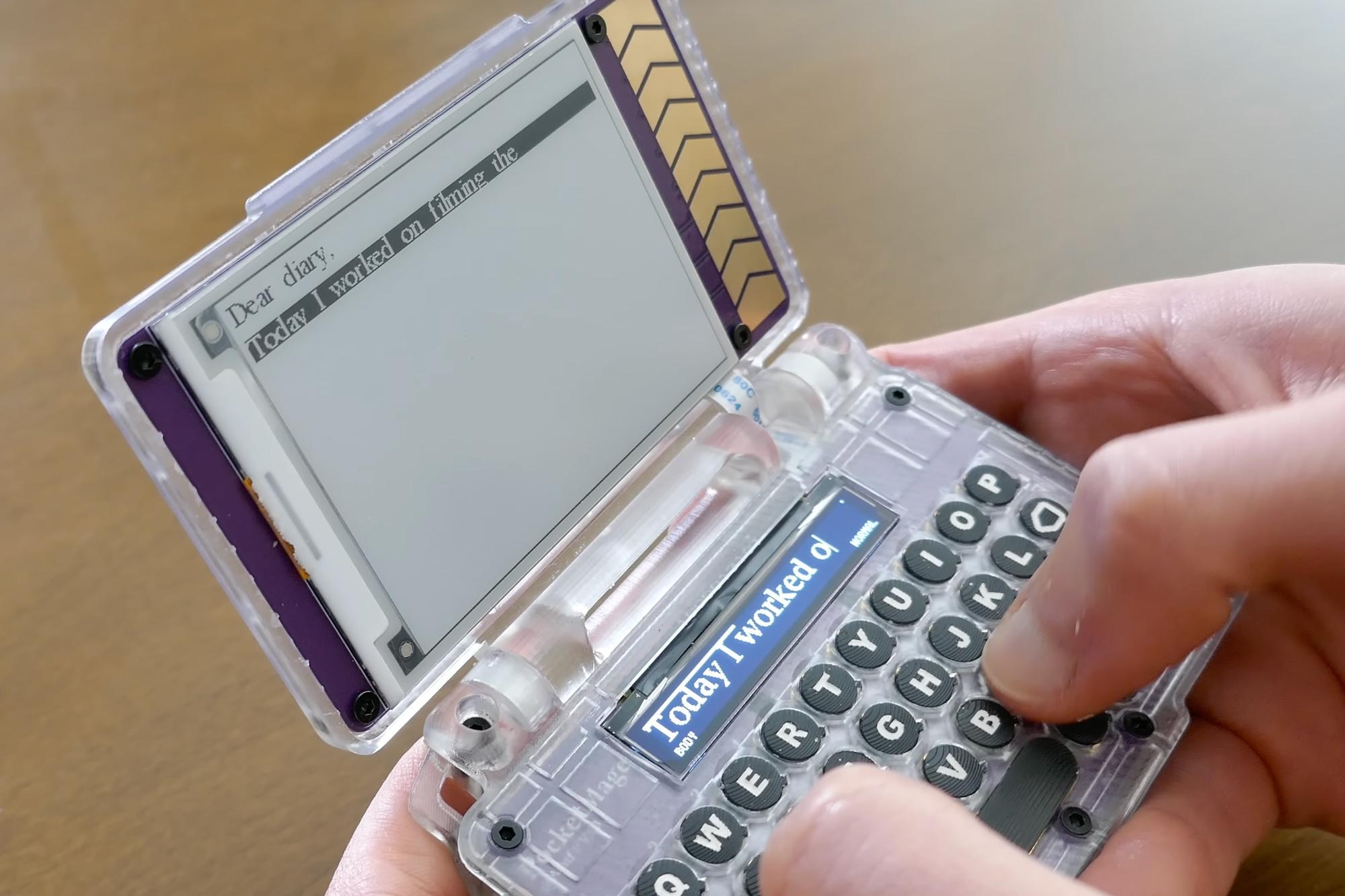 A person holding and typing on the PocketMage PDA.