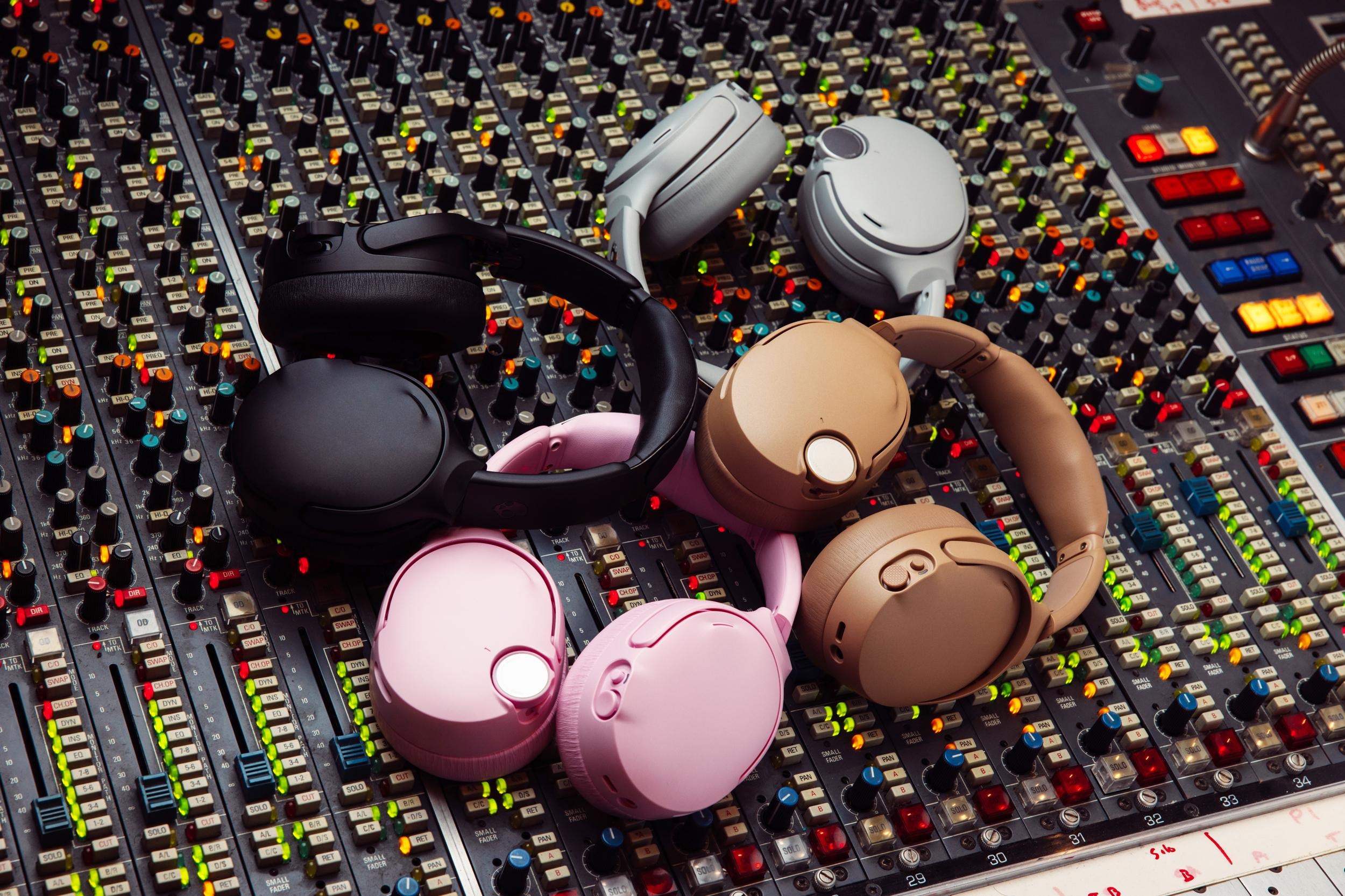 Four versions of Skullcandy’s Crusher 1080 ANC headphones piled on an audio mixer.