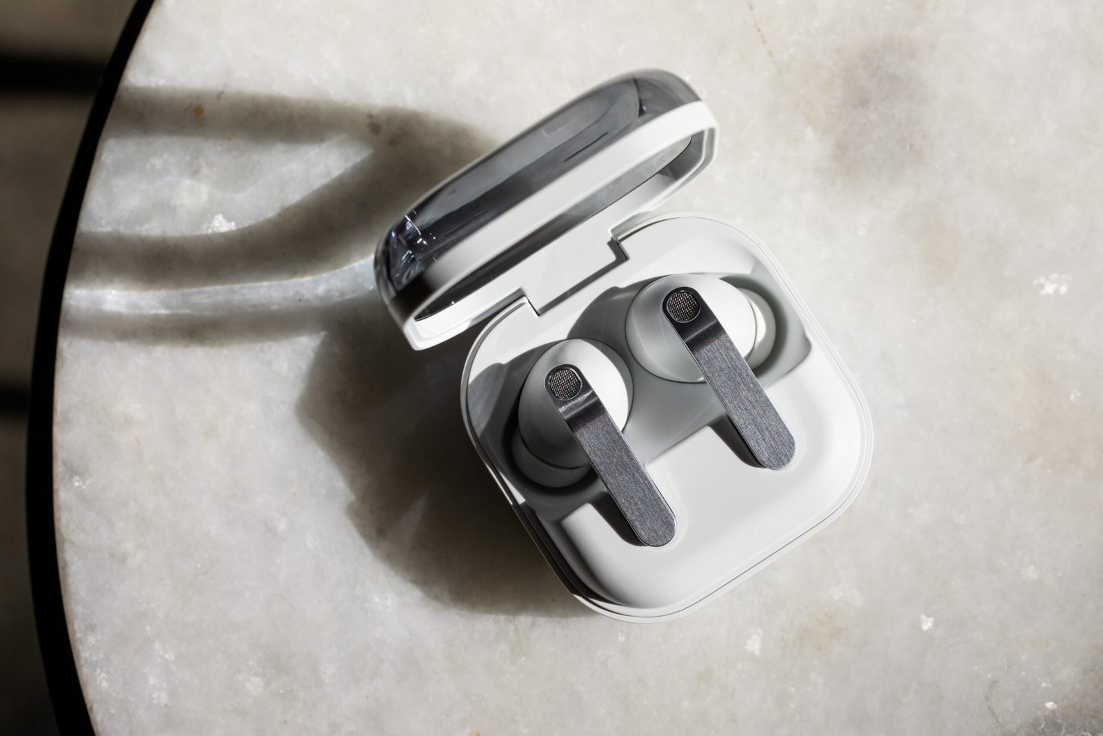 The Samsung Galaxy Buds 4 Pro in their open charging case on a white tabletop.