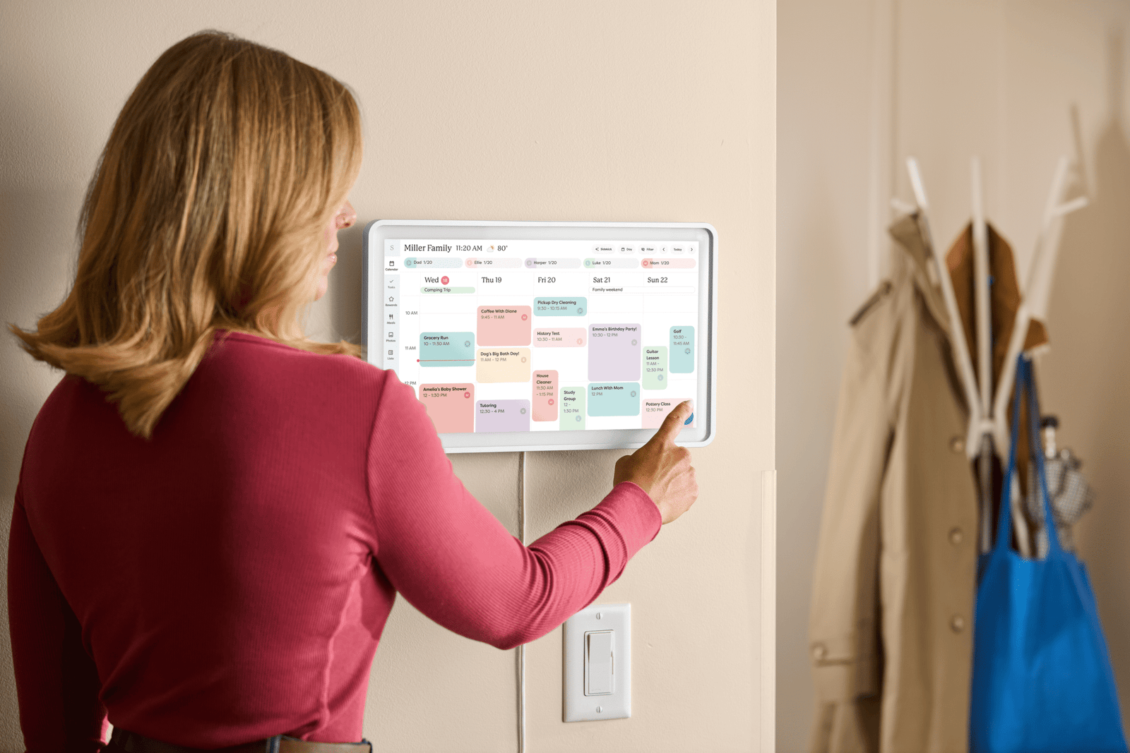 A photo of a person using the Skylight Calendar 2.