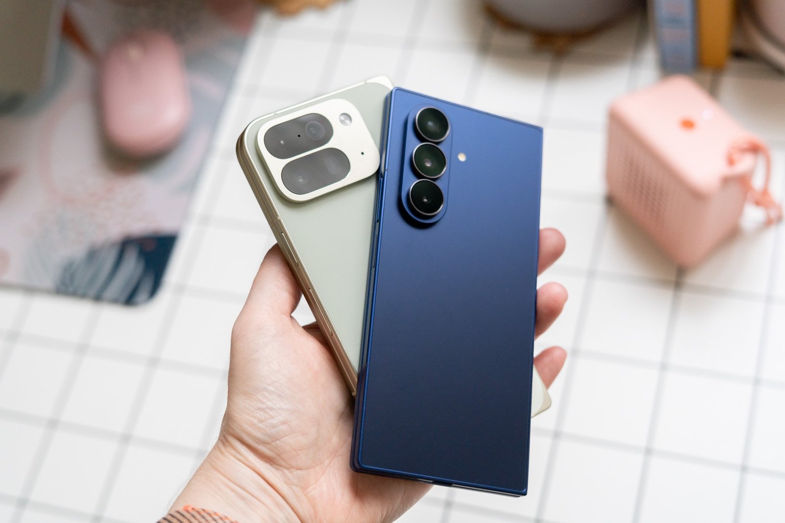 Samsung Galaxy Z Fold 7 and Google Pixel 10 Pro Fold shown in hand.
