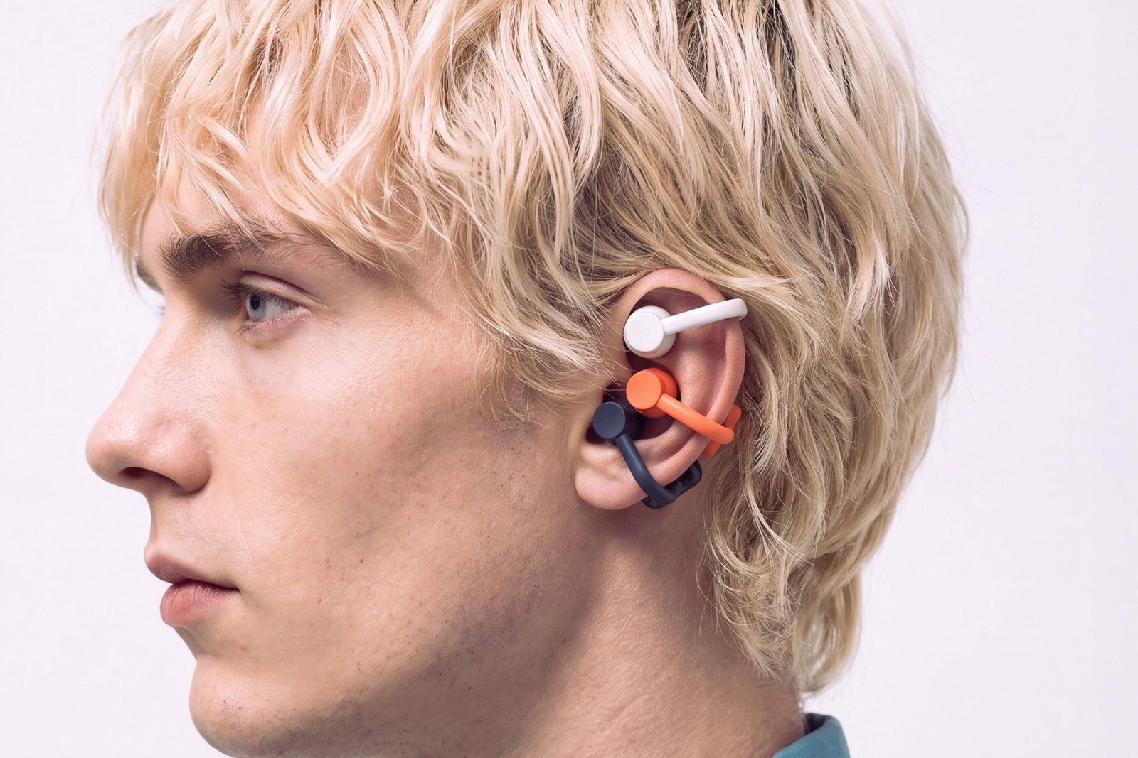 The Nothing CMF Clip Pro open earbuds being displayed on a model.