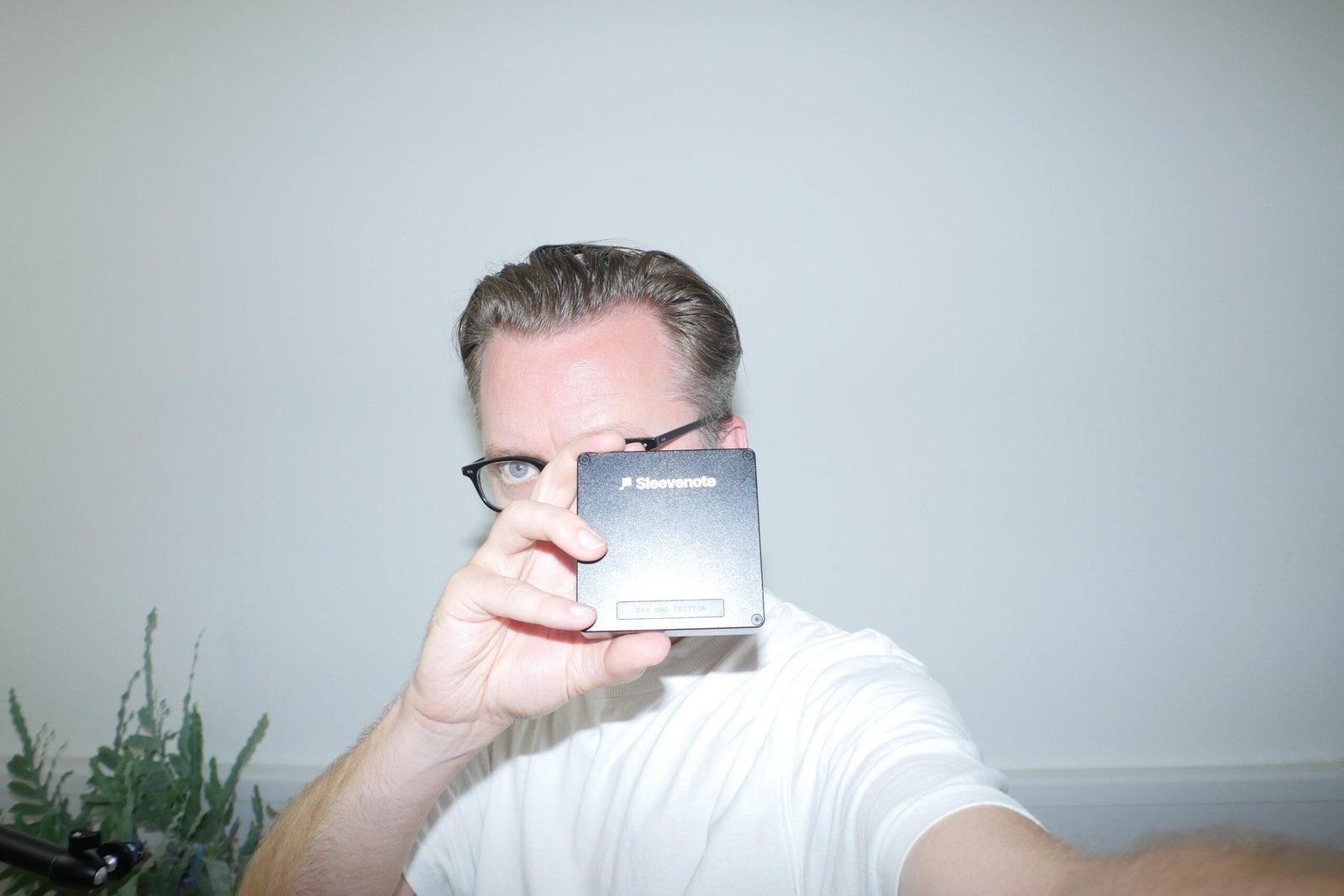 Musician Tom Vek taking a selfie with his Sleevenote music player.