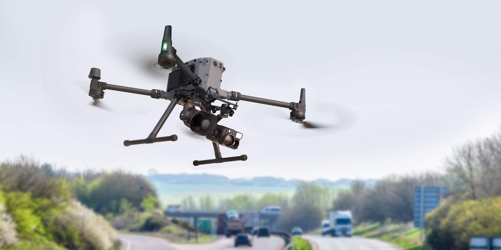 An image of a DJI drone with a Zenmuse V1 speaker accessory