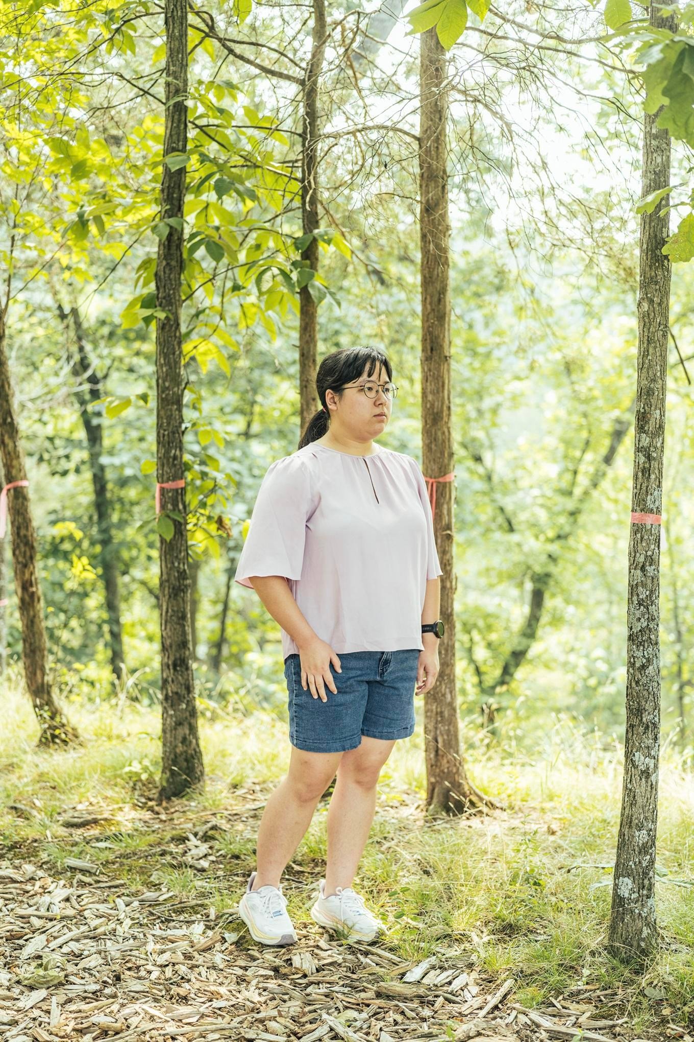 Madison Taggart stands in her backyard among trees marked by pink ribbons to show where a proposed transmission tower would go. Madison Taggart stands in her backyard among trees marked by pink ribbons to show where a proposed transmission tower would go.