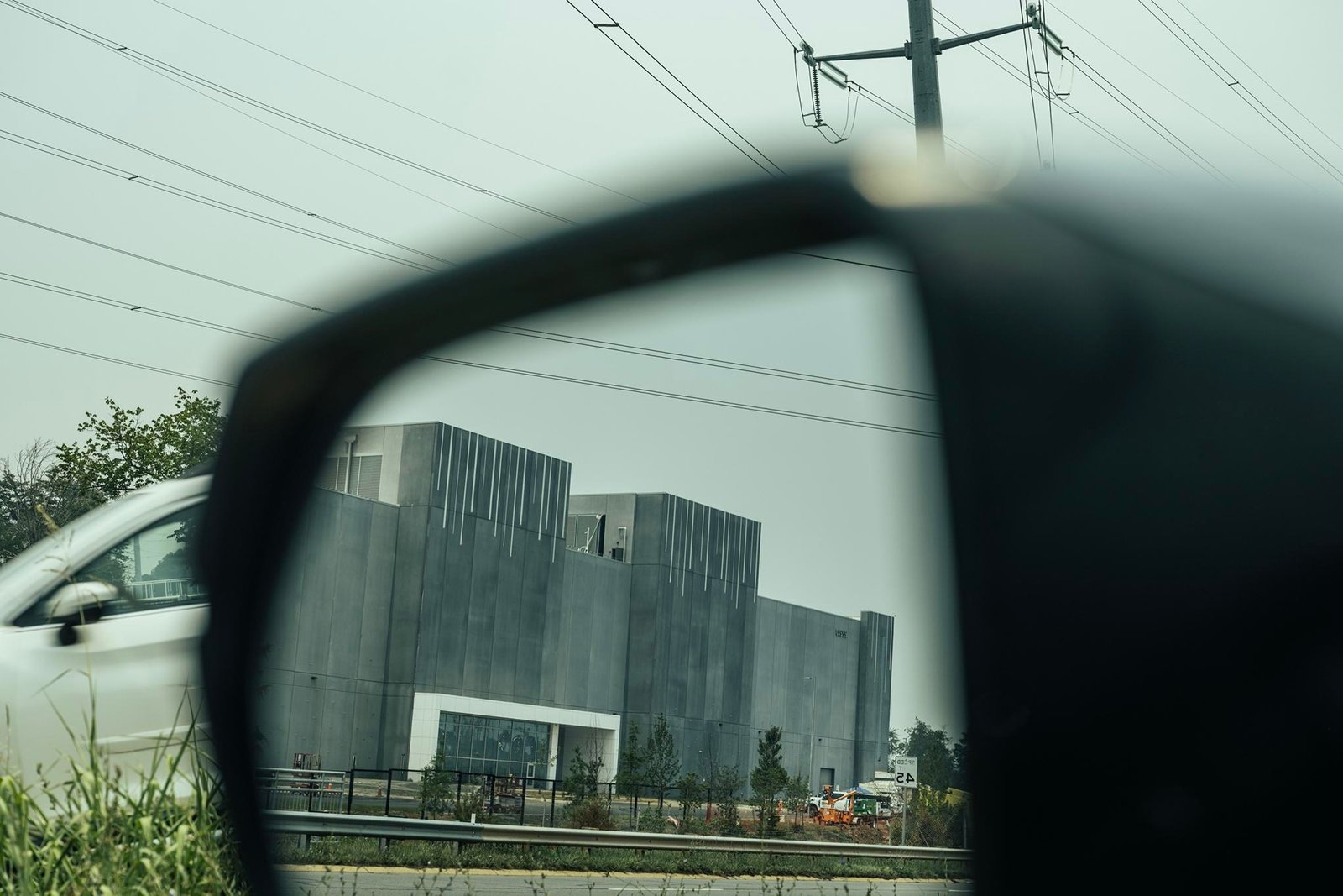 A data center viewed in a side mirror of a car in Ashburn, Virginia. A data center viewed in a side mirror of a car in Ashburn, Virginia.