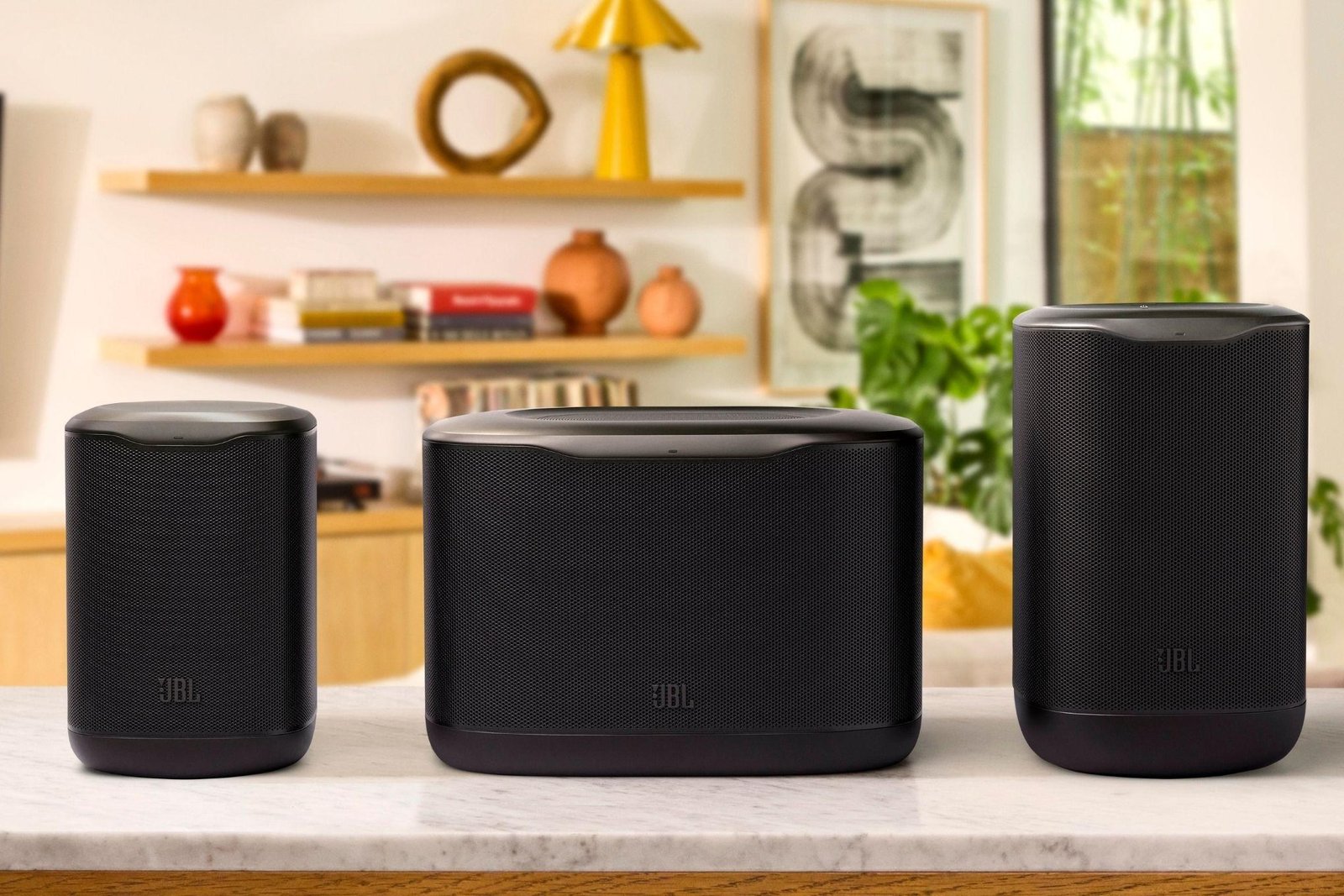 The JBL Cove series speakers displayed on a side table.