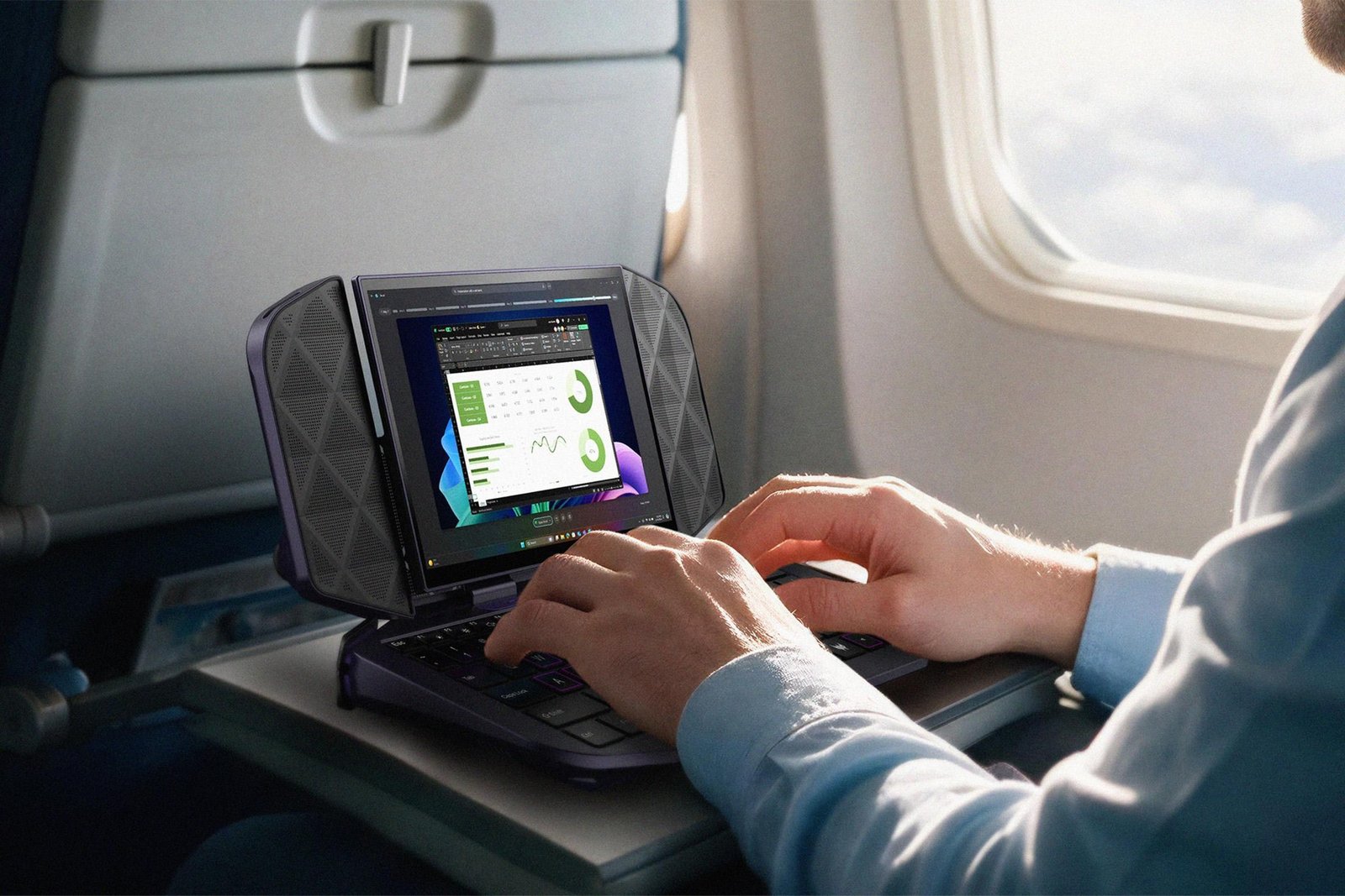 A person on a plane types on the Acer Project DualPlay Mini Concept's tiny keyboard.