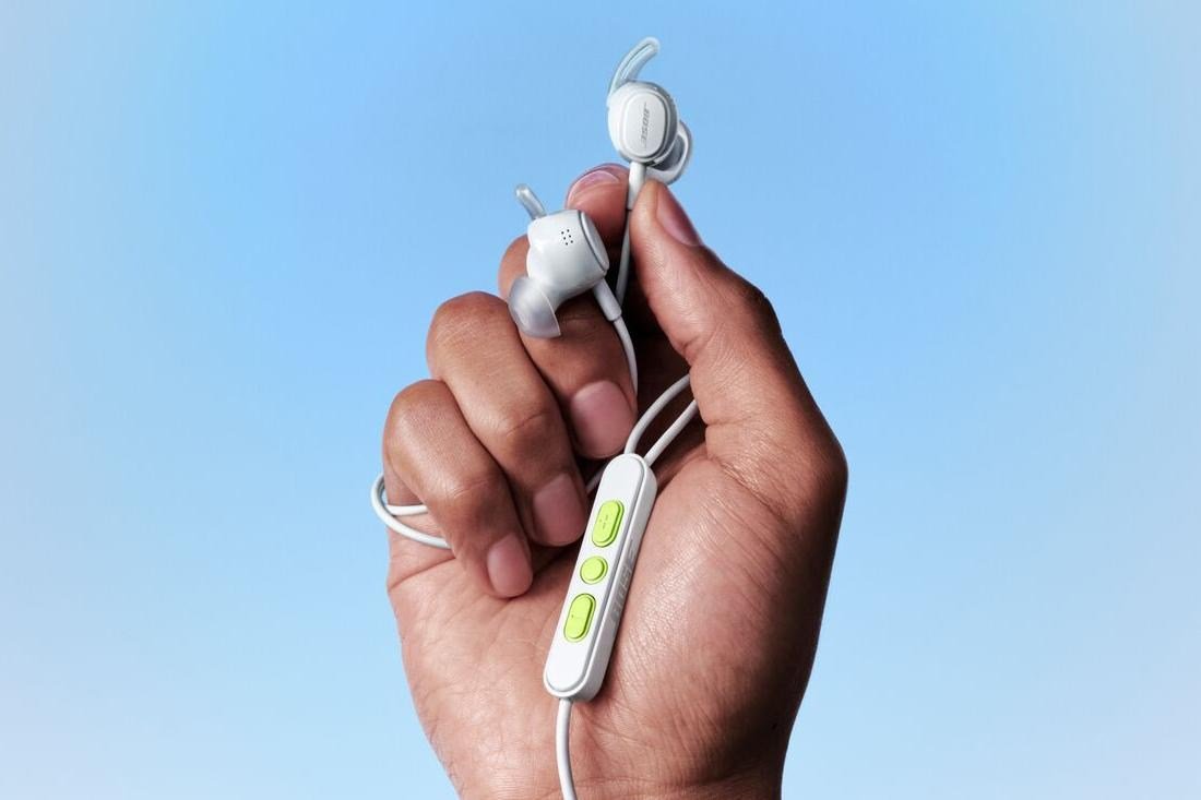 A person holding the Bose Noise Canceling Wired Earbuds in one hand.