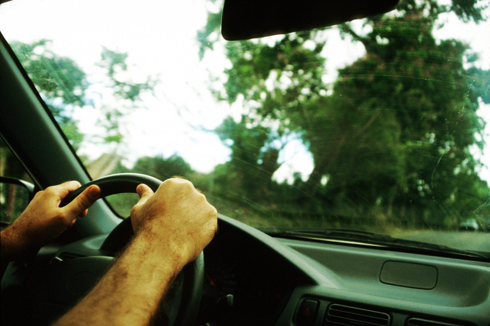 Hands of man on steering wheel