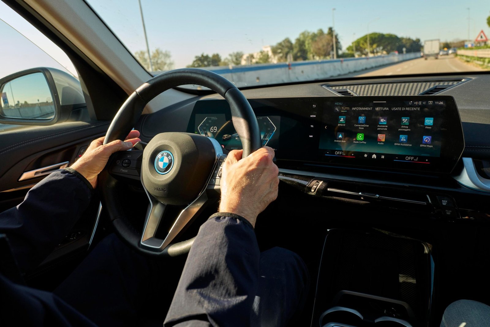 hands on steering wheel in a BMW
