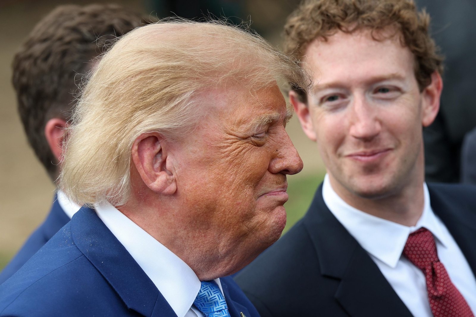 WASHINGTON, DC - SEPTEMBER 29: CEO of Meta Platforms Mark Zuckerberg (R) looks on as U.S. President Donald Trump holds a press briefing with AI executives following a meeting on artificial intelligence, outside the West Wing of the White House on September 29, 2026 in Washington, DC. The meeting comes as some have called for a slowdown in AI development amid rising safety concerns.