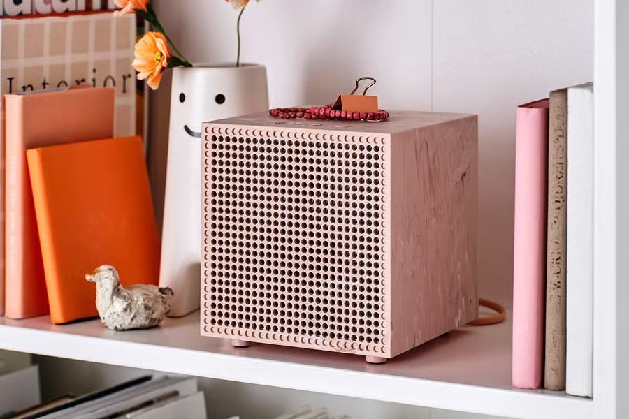 Ikea’s Badkruka wireless speaker in pink on a bookshelf.