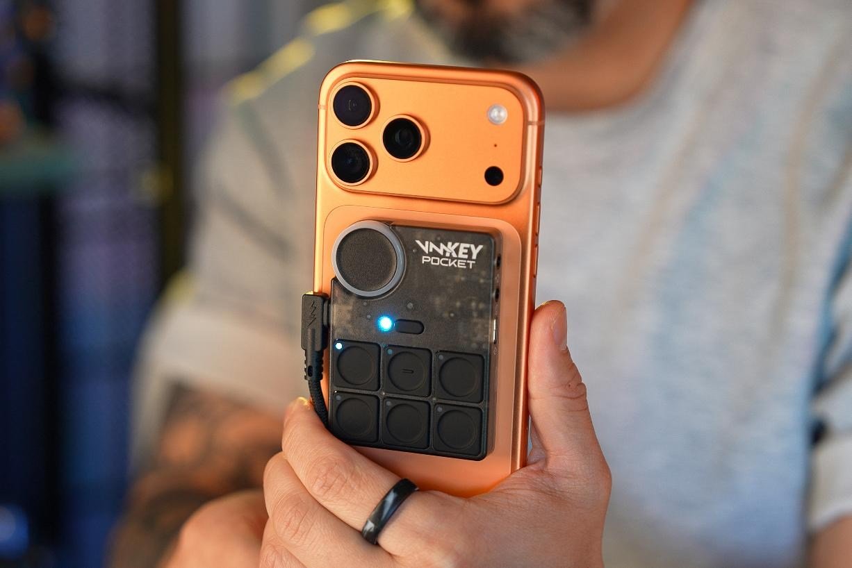 An iPhone with the Voicemod Key Pocket voice changer attached to the back magnetically.