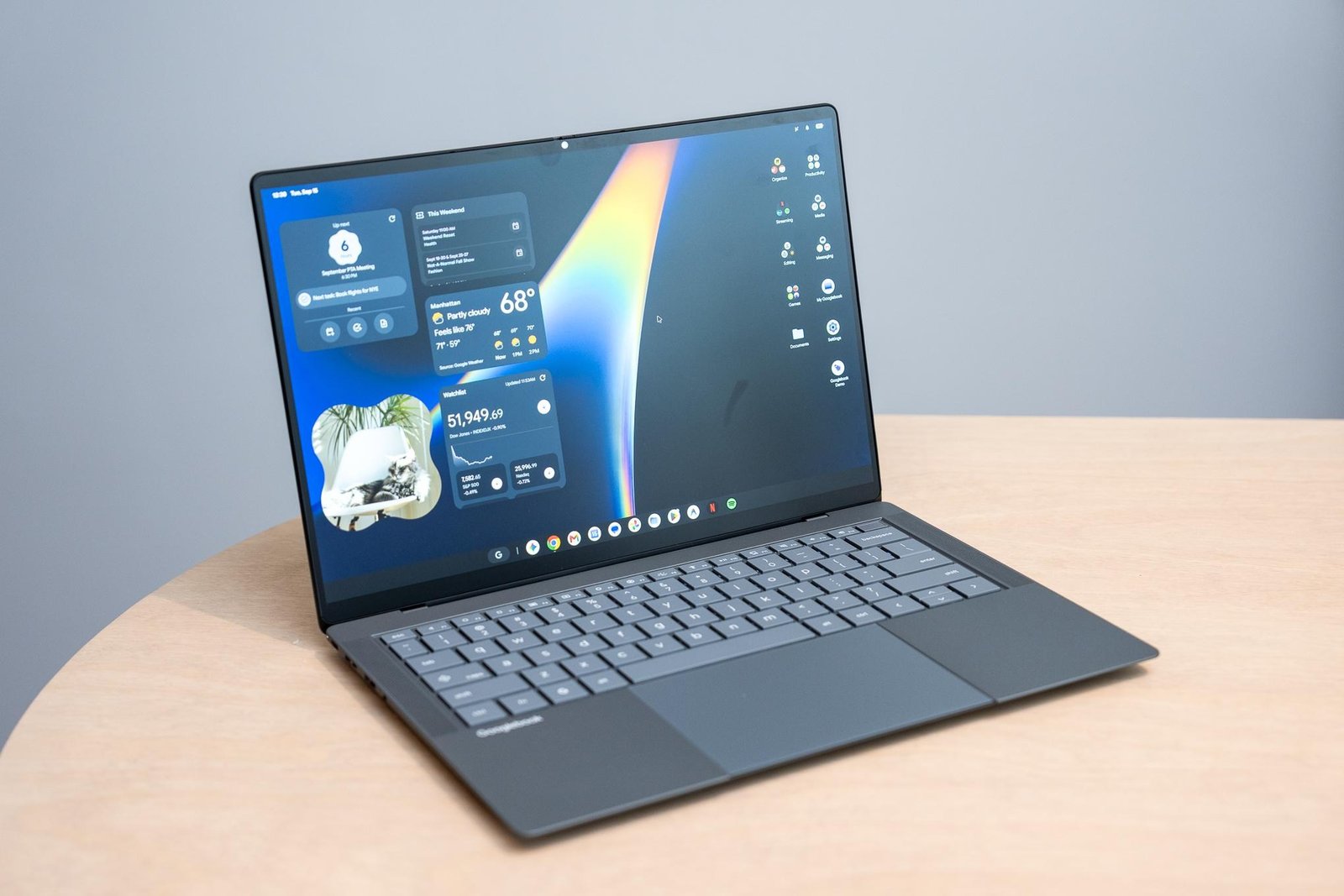 An Asus Googlebook 14 laptop on a wood table.