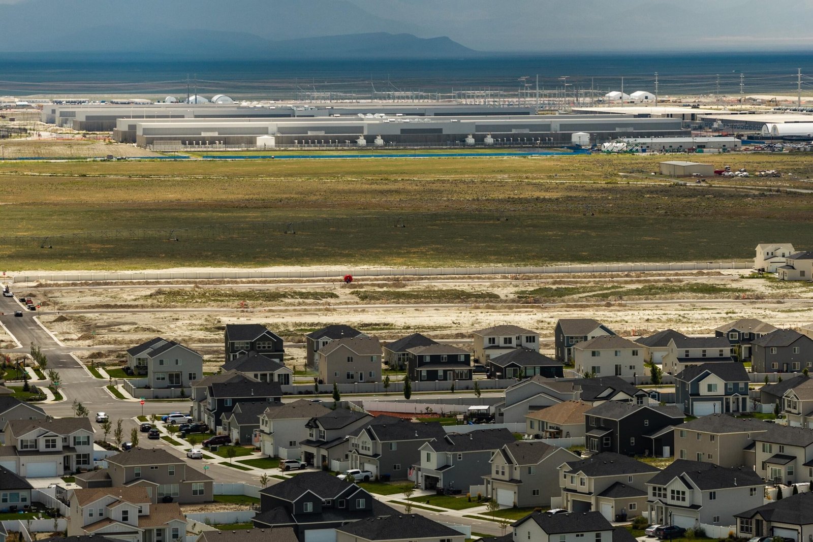 Aerial view of Utah suburbs with Meta's Eagle Mountain data center in the distance.
