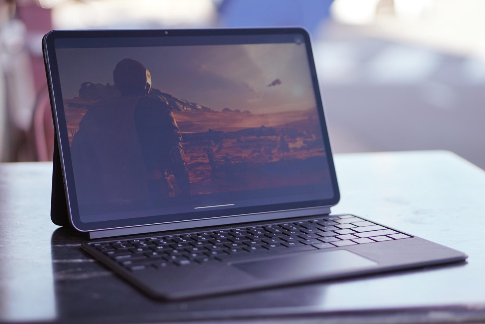 A photo of a tablet on a table, in a keyboard case.
