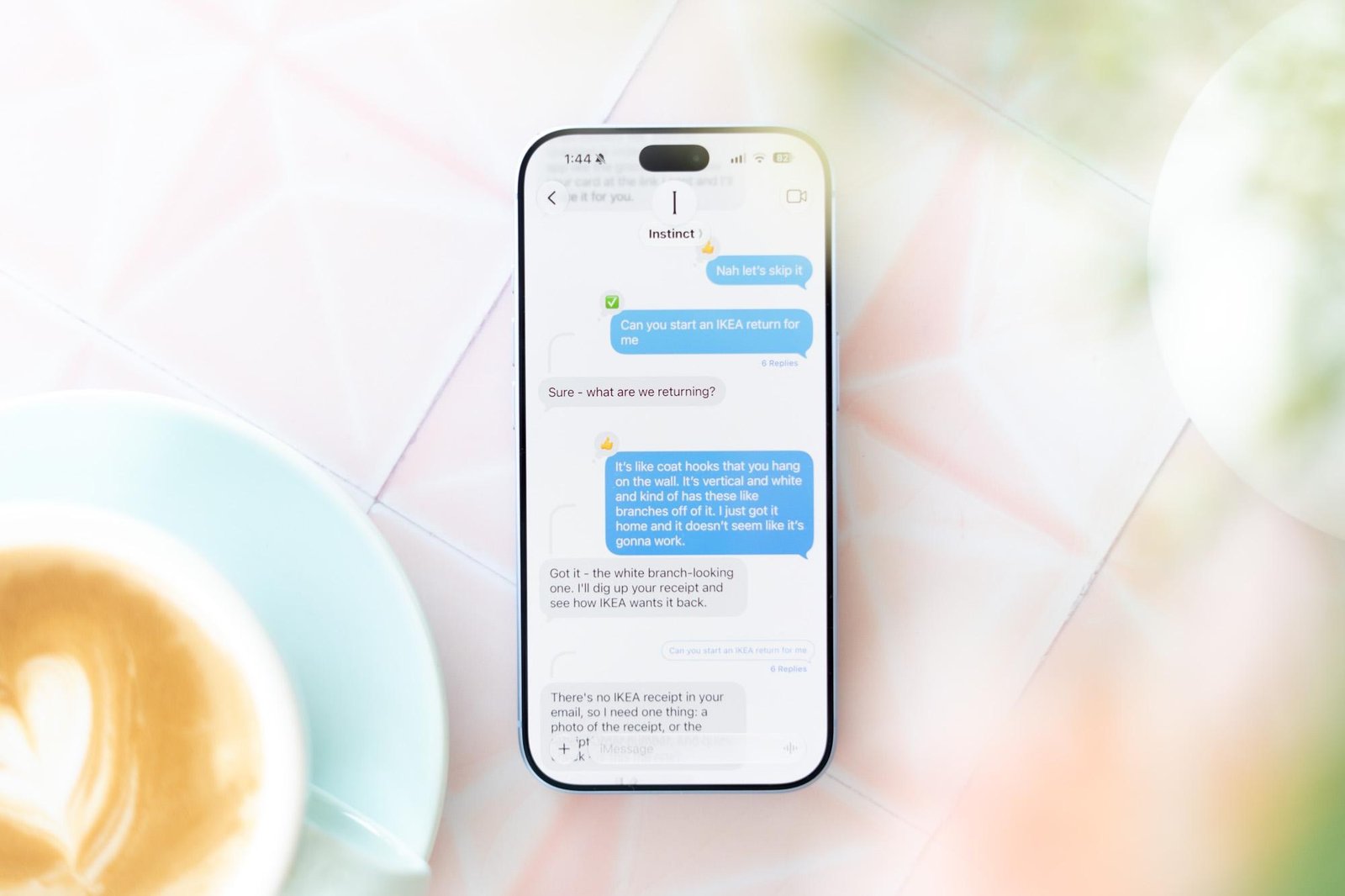Photo of a phone on a table showing Instinct AI texts.