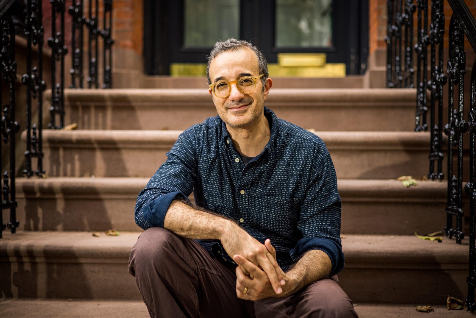 Jad Abumrad on a stoop in Brooklyn.