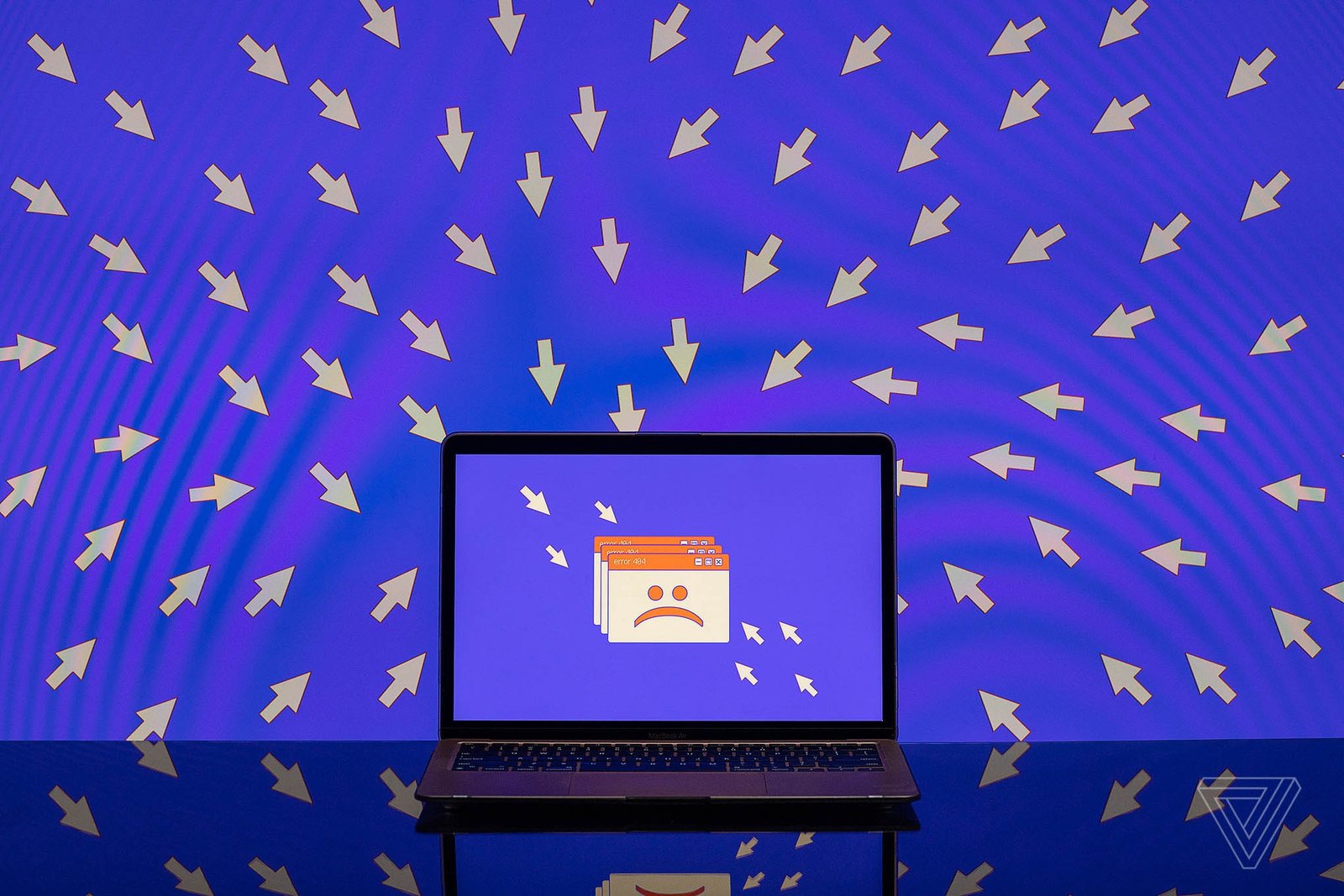 A number of cursors point toward an unhappy face on a laptop