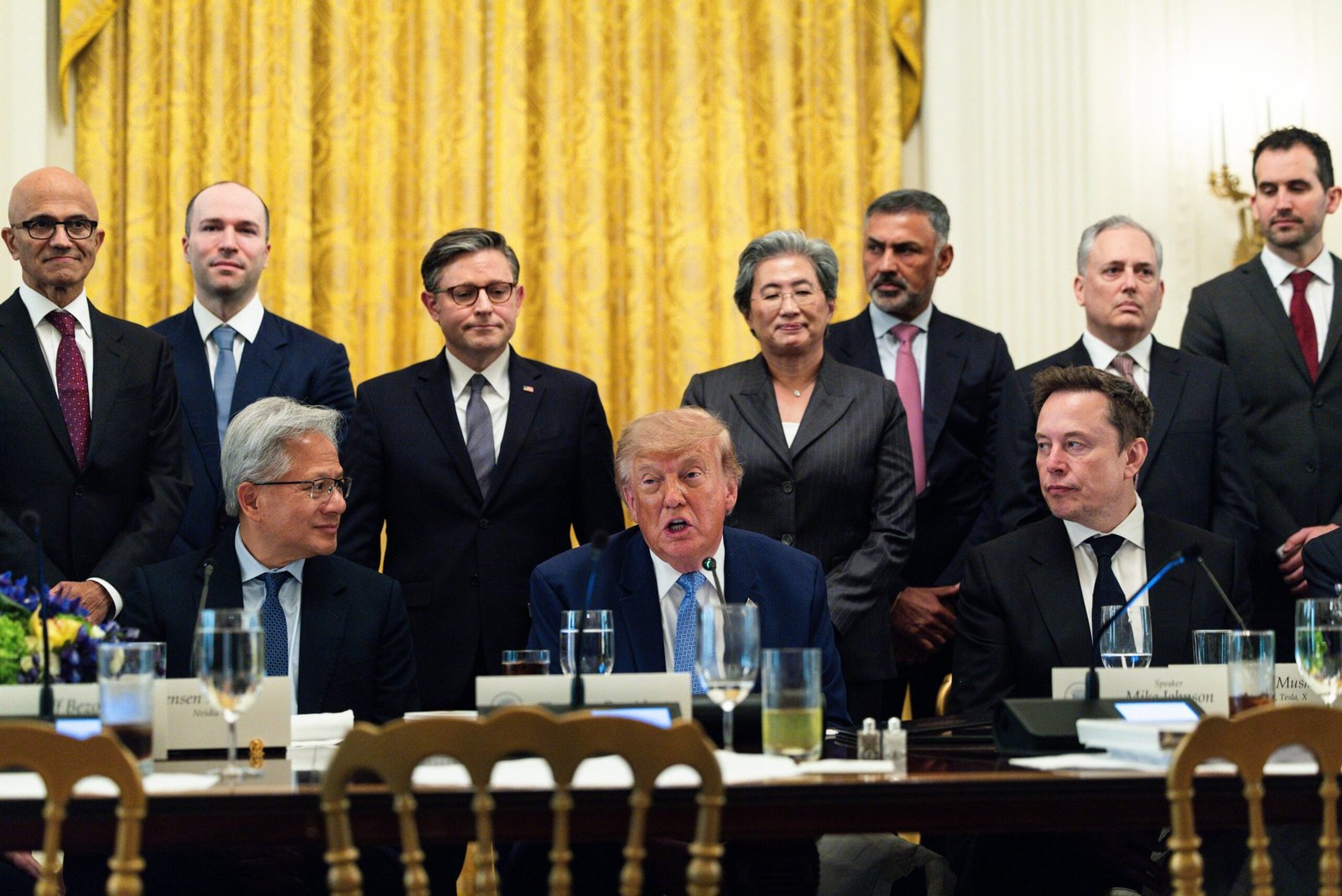 Satya Nadella, chief executive officer of Microsoft Corp., from left, Greg Brockman, president and co-founder of OpenAI Inc., Jensen Huang, chief executive officer of Nvidia Corp., US House Speaker Mike Johnson, a Republican from Louisiana, US President Donald Trump, Lisa Su, chair and chief executive officer of Advanced Micro Devices Inc. (AMD), Nikesh Arora, chief executive officer at Palo Alto Networks Inc., and Elon Musk, chief executive officer of Tesla Inc., during a meeting with tech executives on artificial intelligence in the East Room of the White House in Washington, DC, US, on Tuesday, Sept. 29, 2026. The gathering follows a surge in concern about AI potentially posing a threat to humans. Photographer: Tierney L. Cross/The Washington Post/Bloomberg via Getty Images