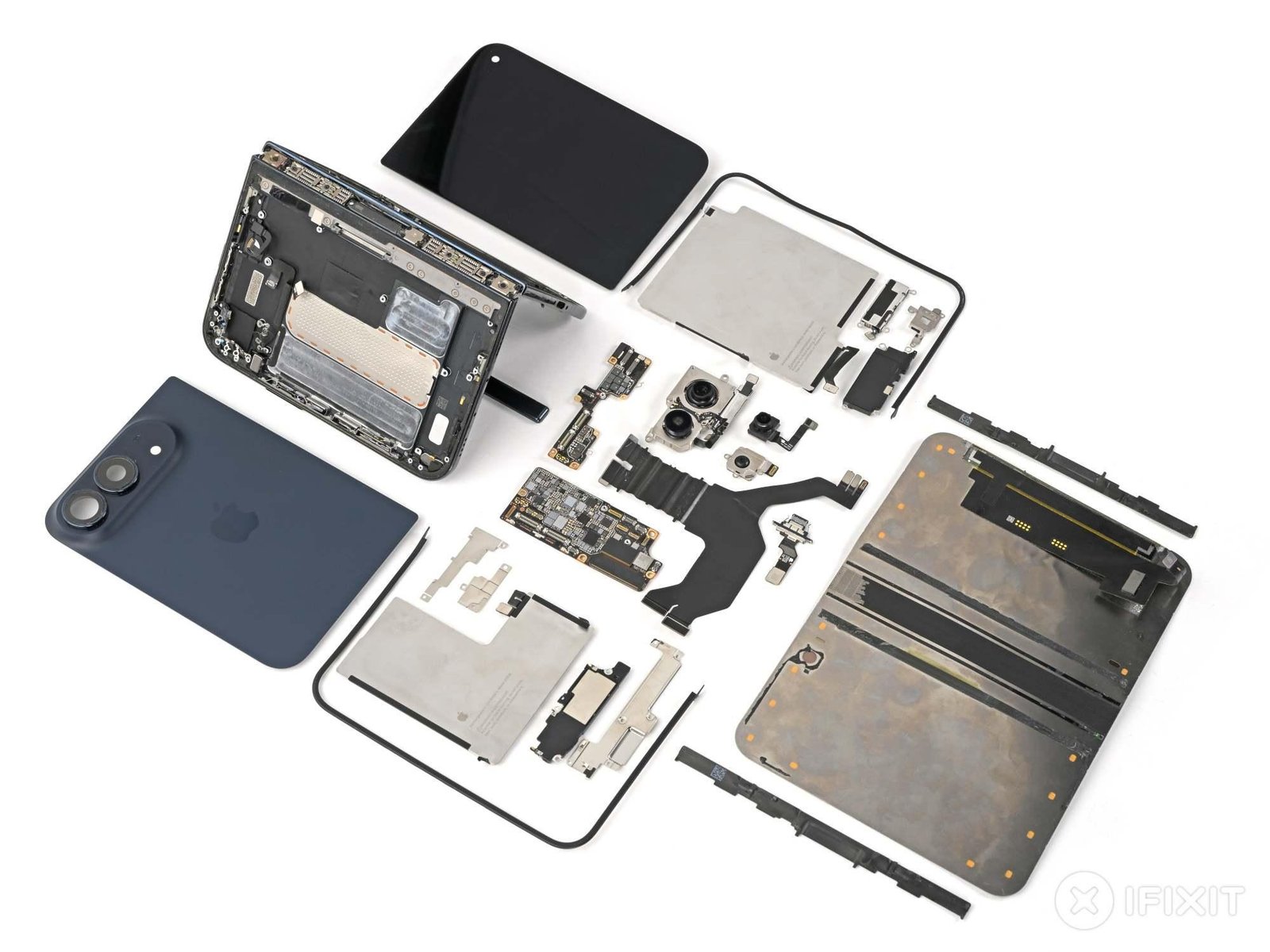 iPhone Duo disassembled and all its components laid out on a white table.
