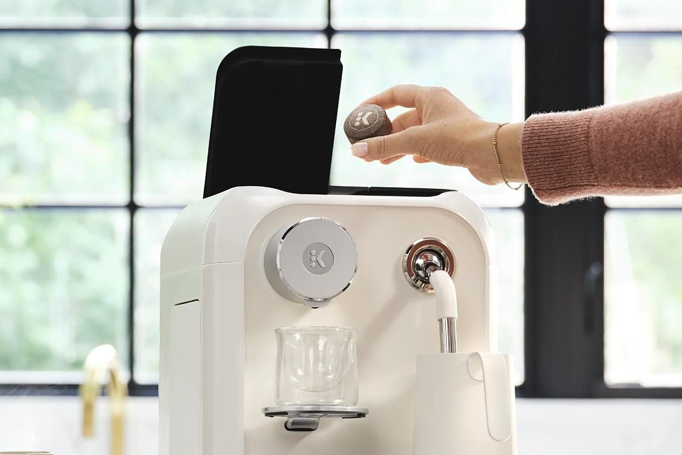 A person inserts an AltaRound into the Keurig Alta coffee maker.
