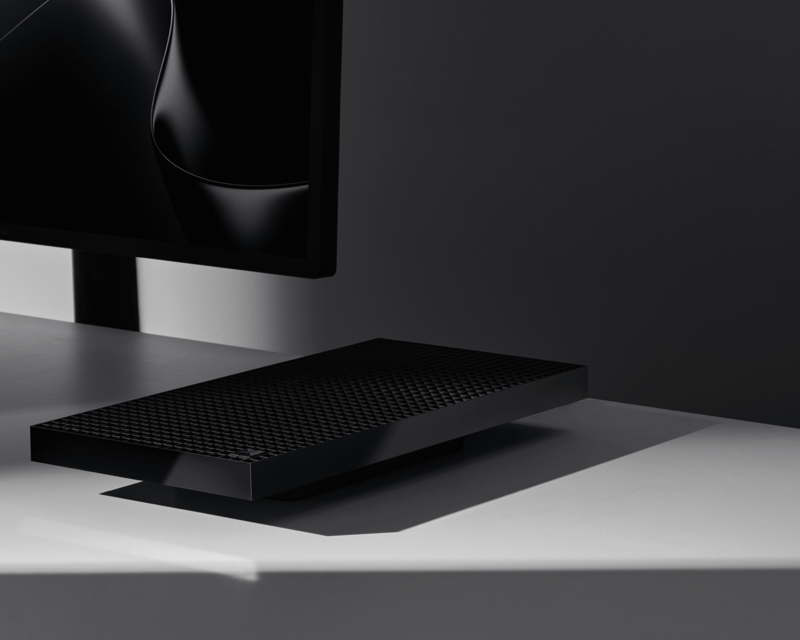 A Microsoft Surface RTX Spark Dev Box on a desk by a monitor