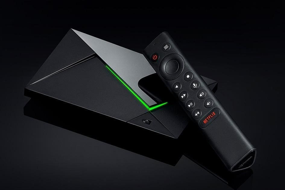 The Nvidia Shield TV Pro streaming box with its remote laying on it.