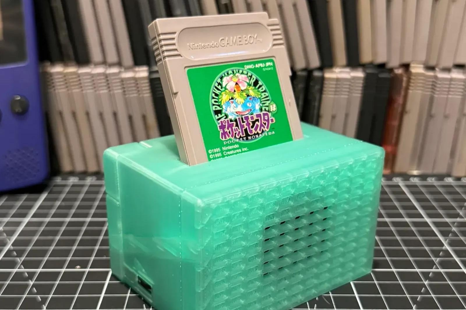The Retro Song Bird music player with a cartridge inserted in front of a pile of Game Boy Carts.