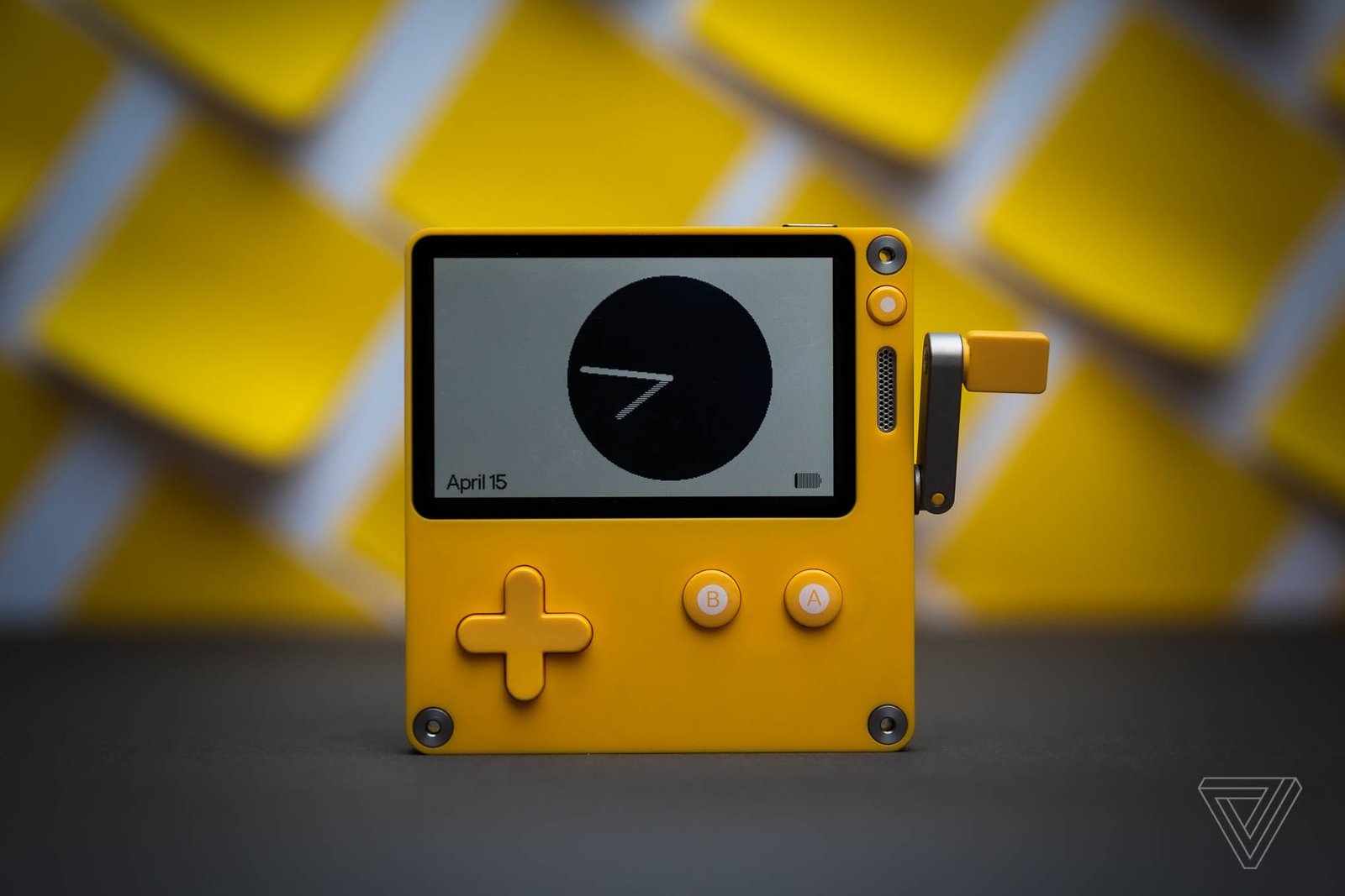 A photo of the Playdate handheld video game console.